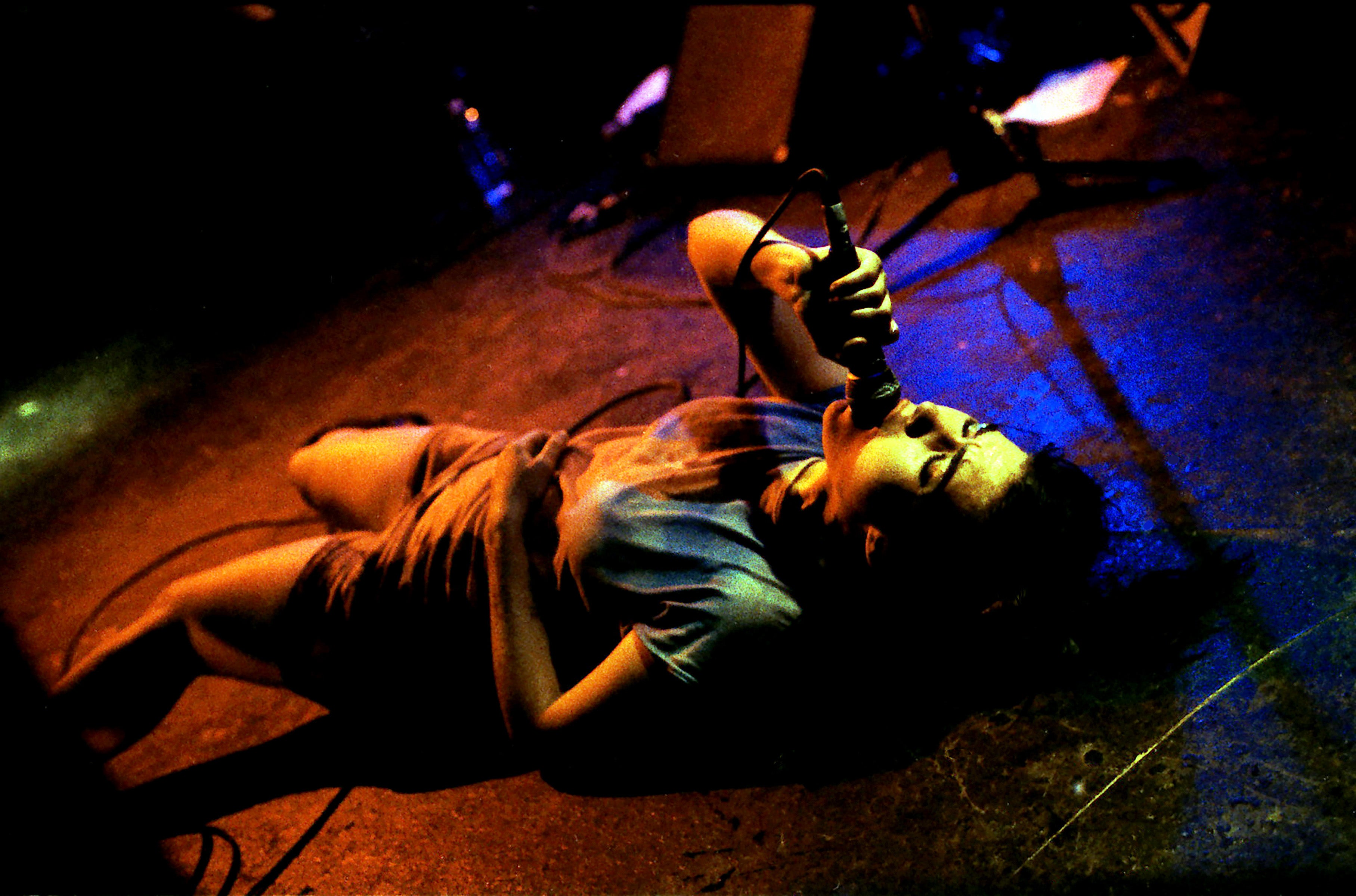 Hanna lies on her back as she performs in Bikini Kill in Hollywood in November 1994