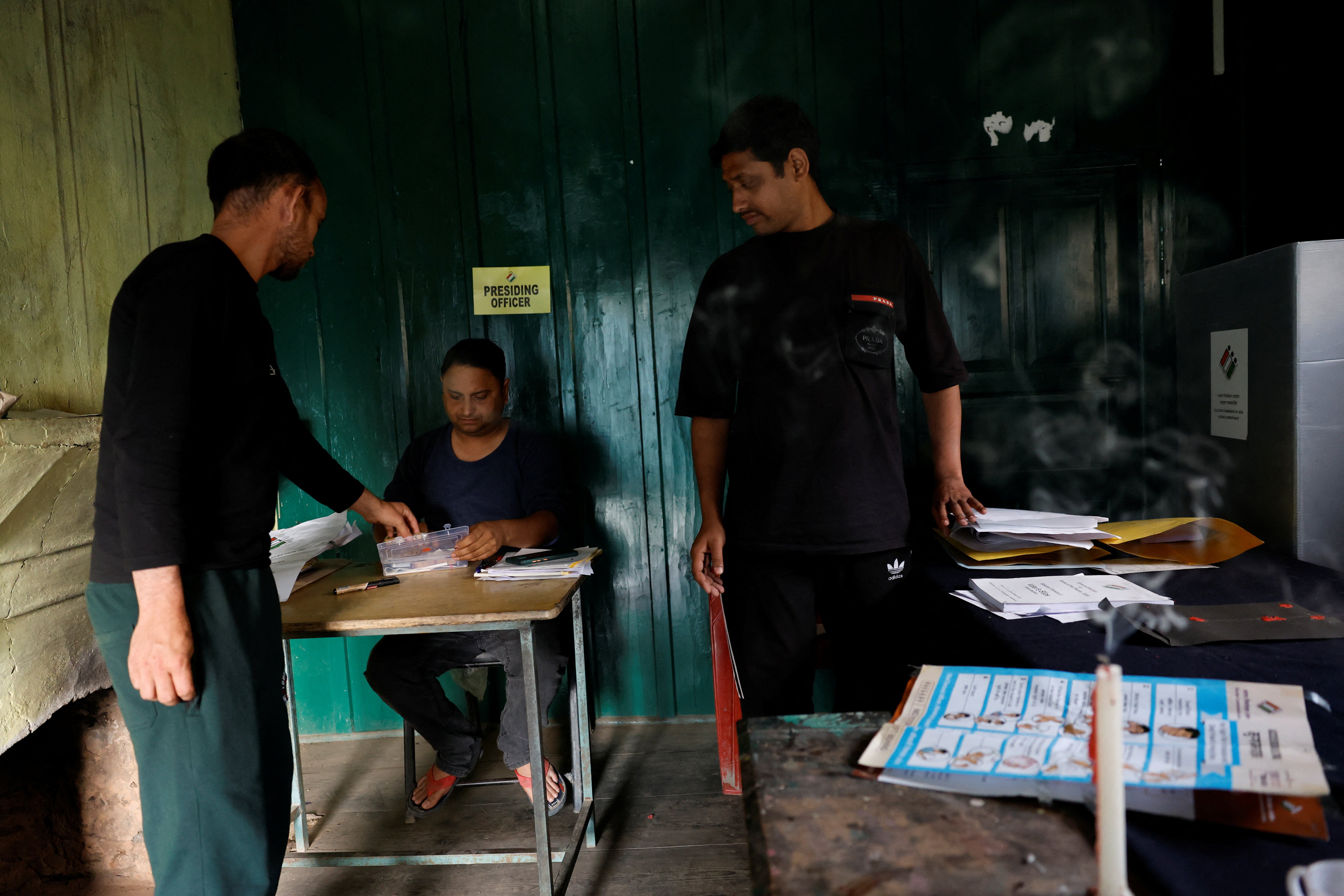 Polling officials make preparations inside a remote polling station in Almi