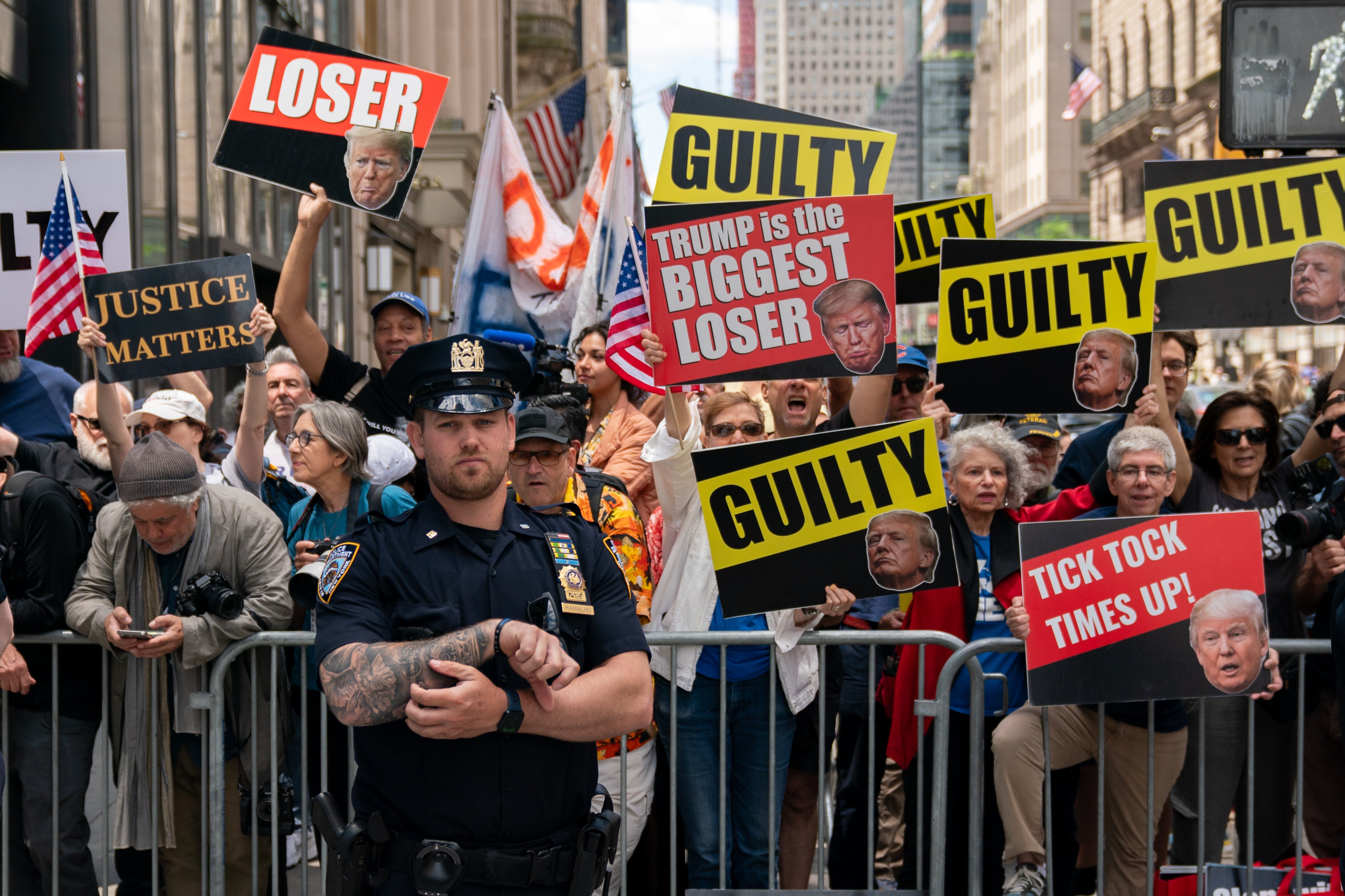 Demonstrators hold up ‘GUILTY’ signs outside Trump Tower as the former president delivers remarks on May 31, one day after he was found guilty of 34 felonies