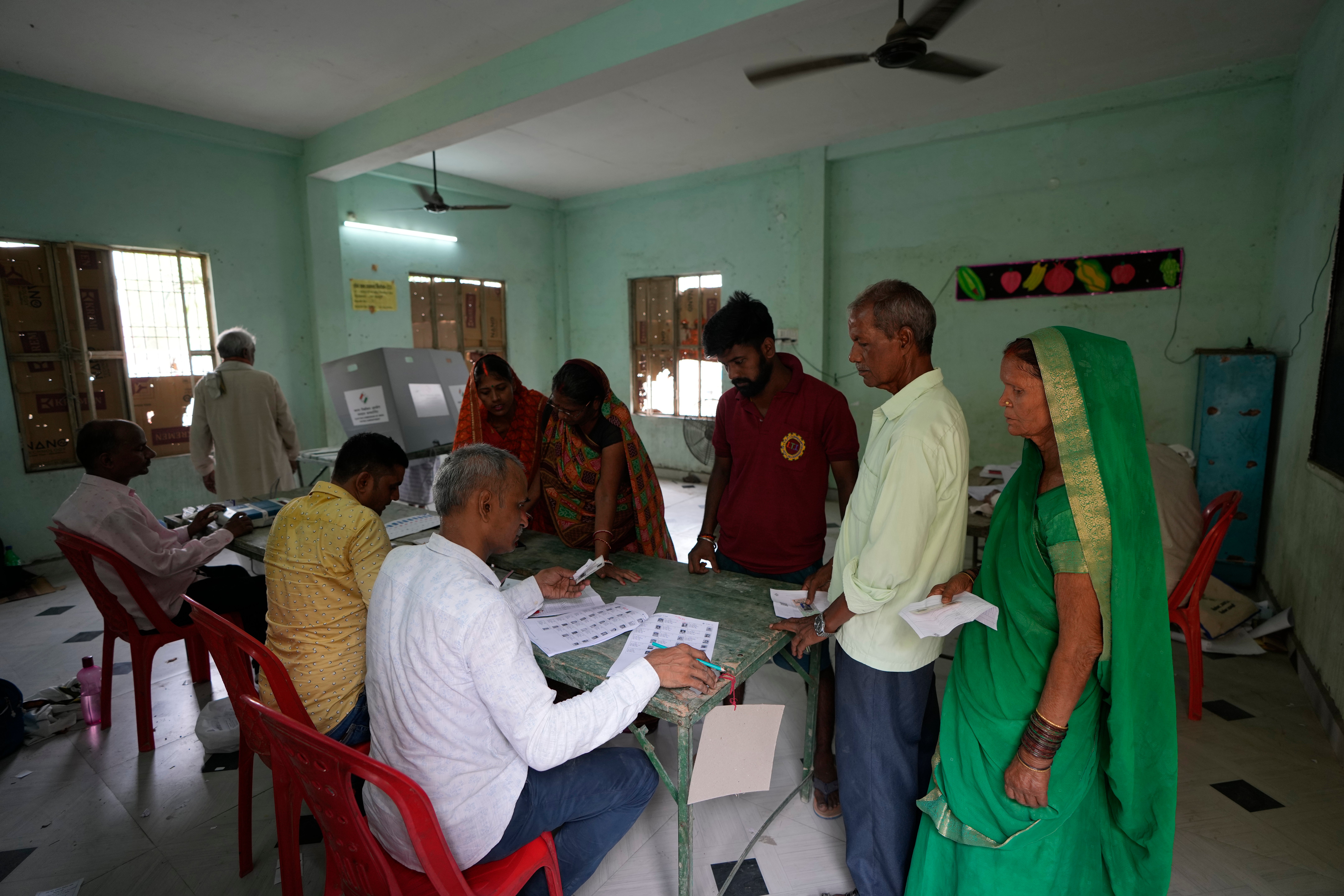 Voters wait for their turn to cast their vote during the seventh and final phase of voting of the national election in Varanasi , India, Saturday, 1 June 2024