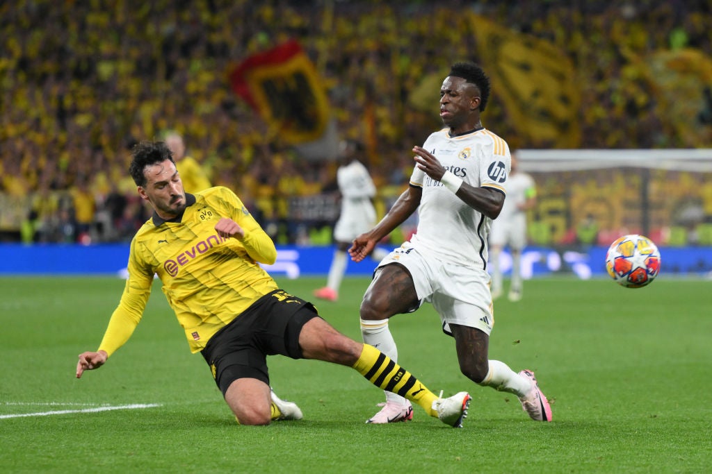 Vinicius Jr of Real Madrid is challenged by Mats Hummels of Borussia Dortmund