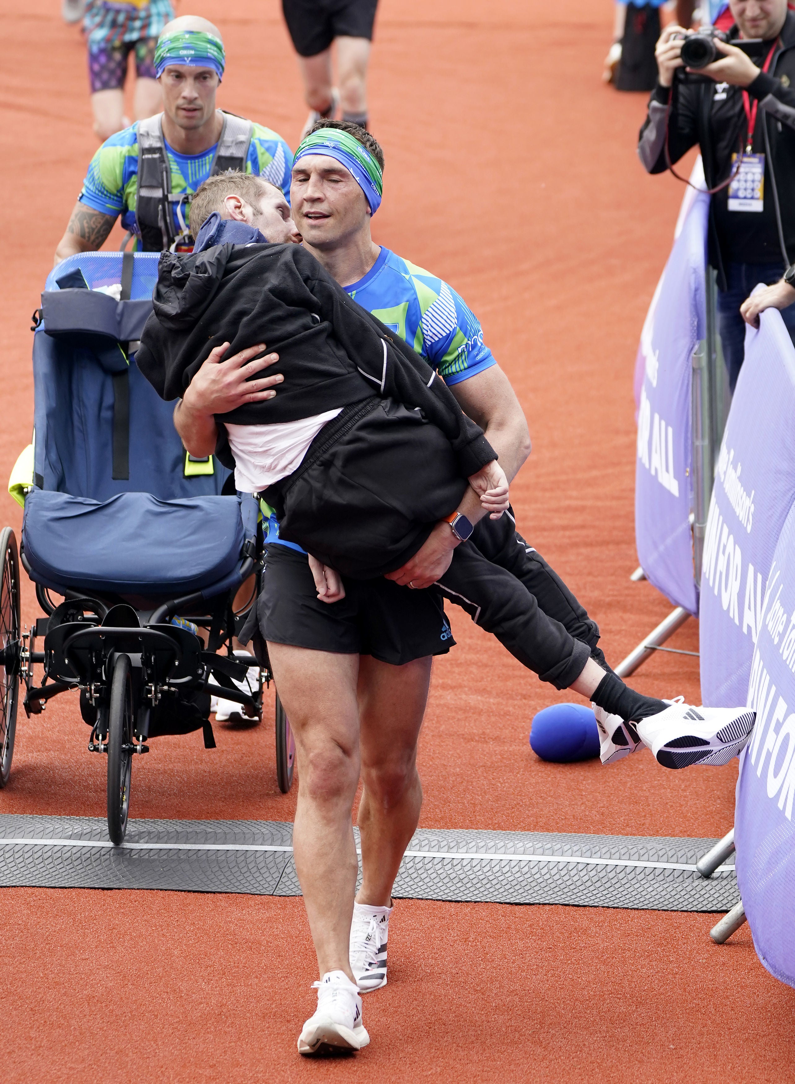 Rob Burrow and Kevin Sinfield crossing the finish line of the Rob Burrow Leeds Marathon in 2023