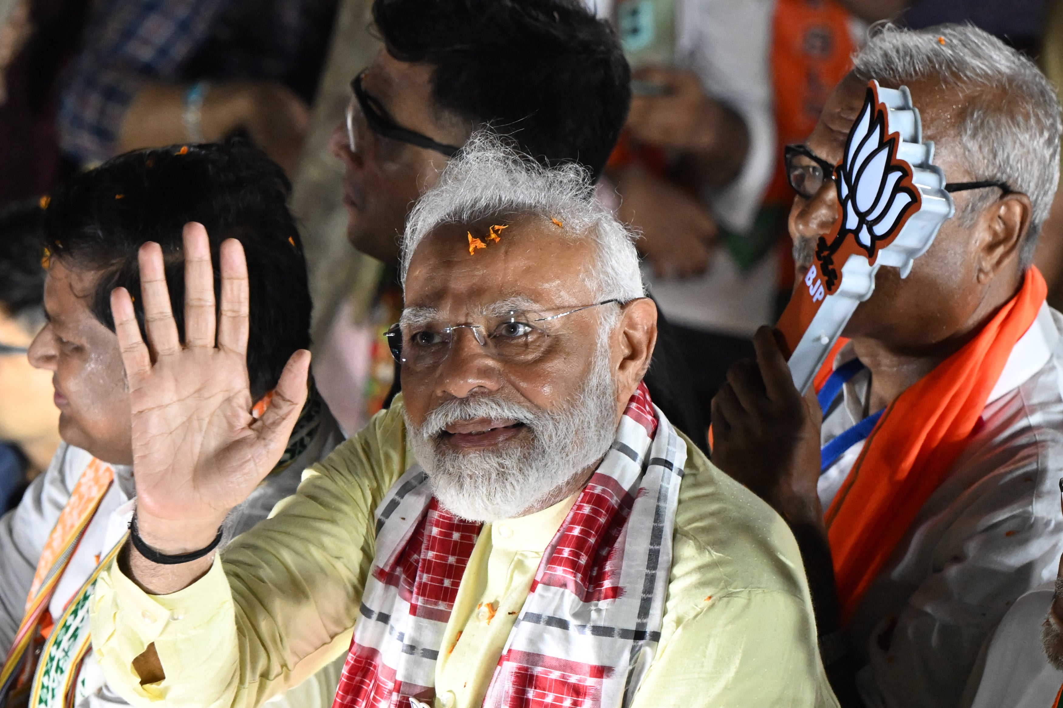 India’s prime minister and leader of the ruling Bharatiya Janata Party Narendra Modi waves to supporters during an election campaign rally