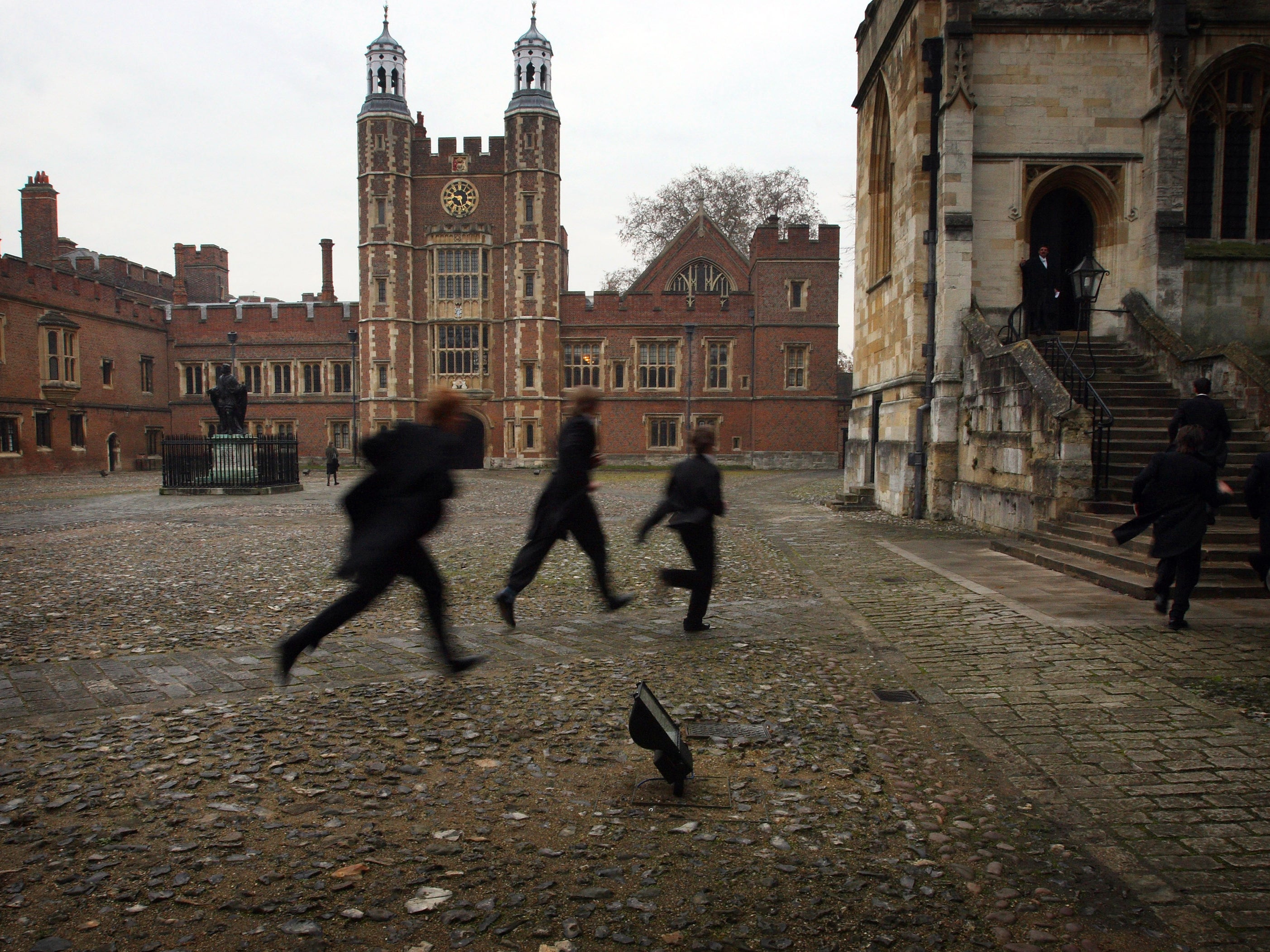 Pupils run across the historic cobbled yard at Eton College