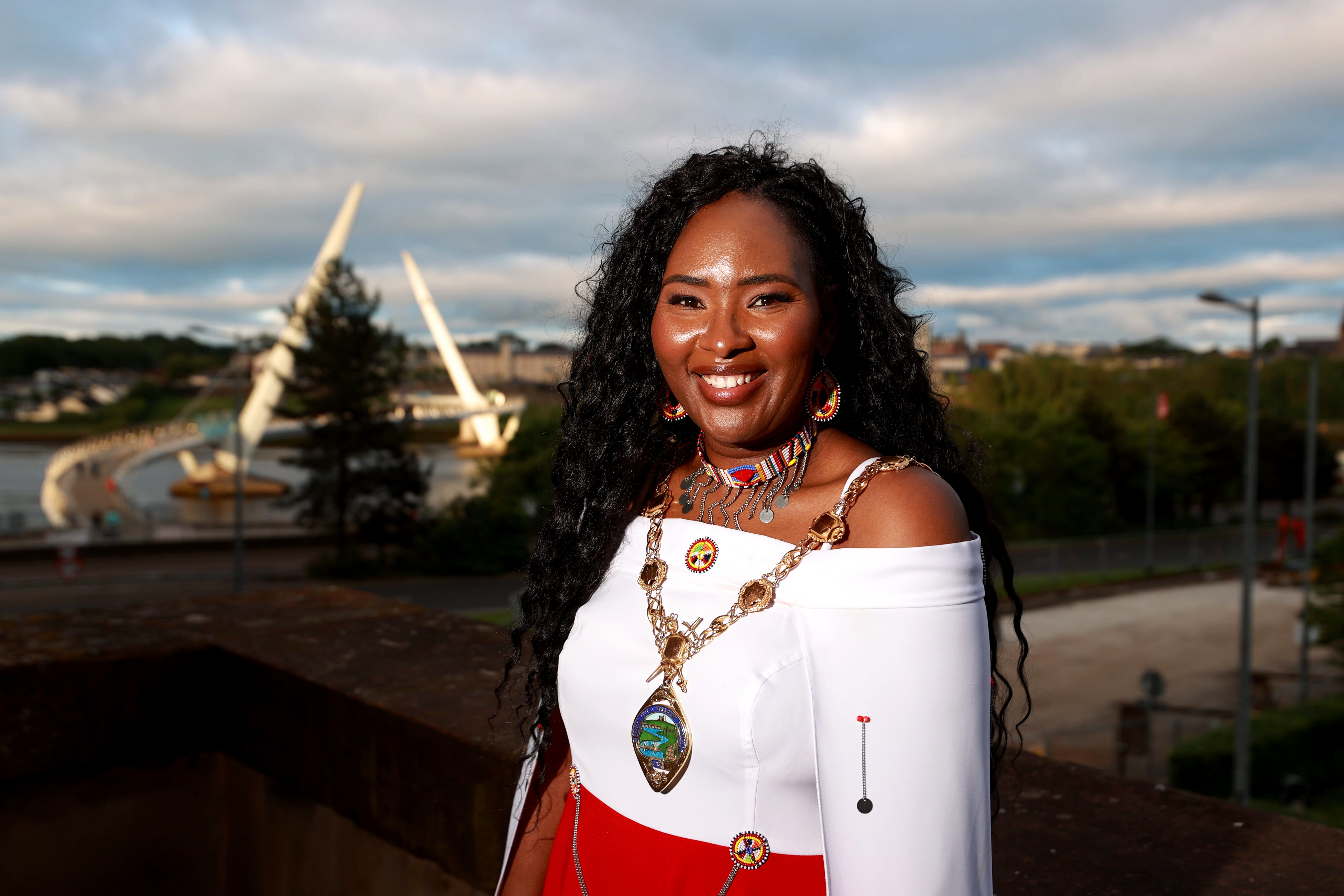 Councillor Lilian Seenoi-Barr stands on the balcony of the Guildhall in Derry City, with the Peace Bridge behind her, after she became the new mayor of Derry City and Strabane District Council, and Northern Ireland’s first black mayor. (Liam McBurney/PA)