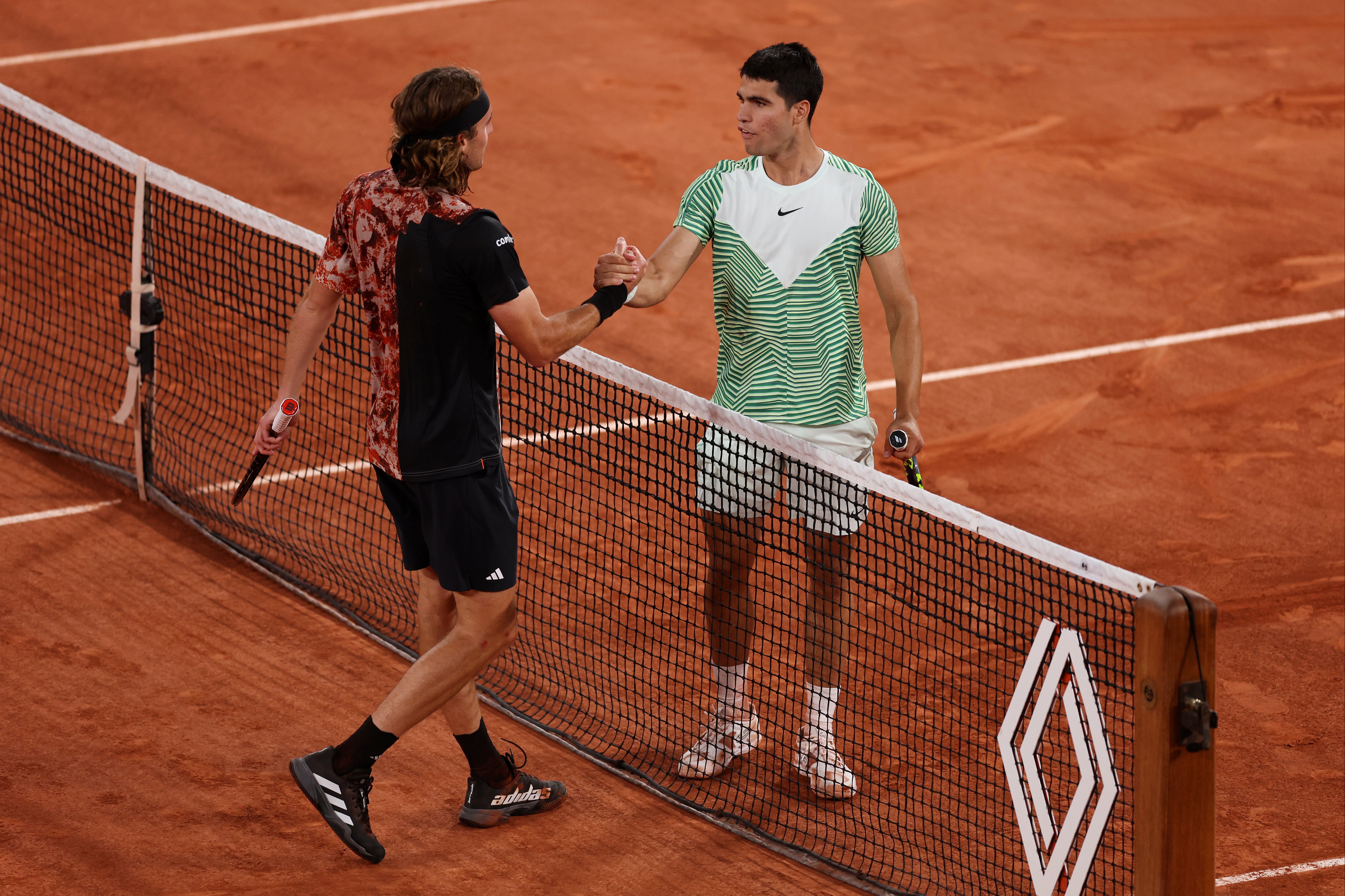 Carlos Alcaraz (right) beat Stefanos Tsitsipas in the French Open quarter-finals last year