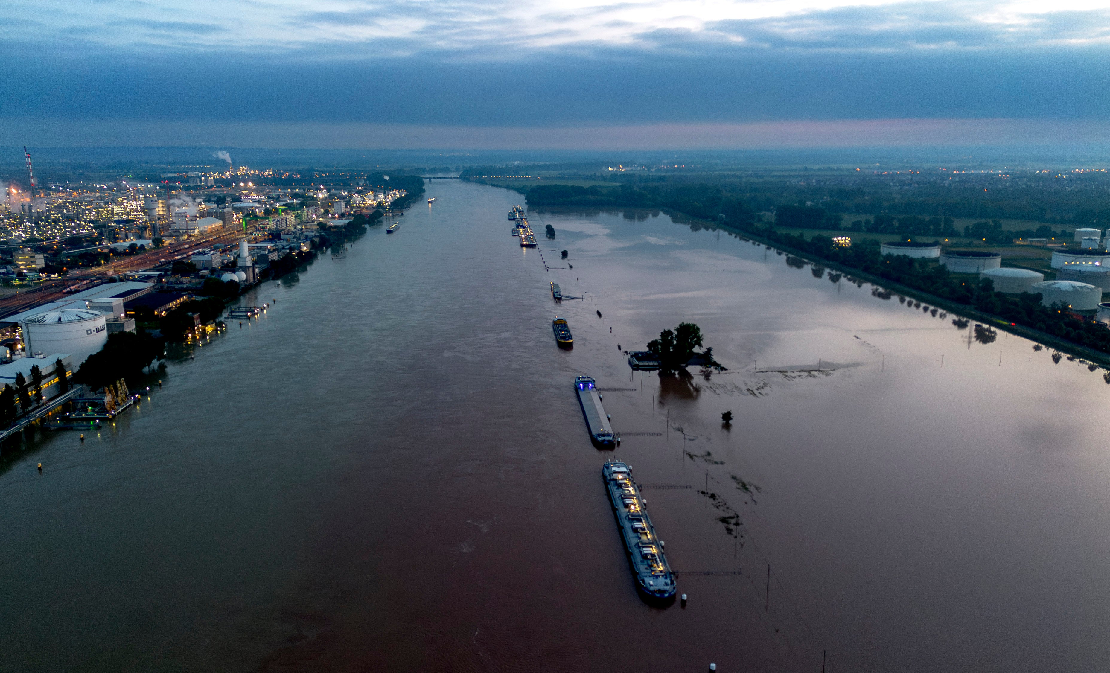 Cargo ships park at the bank of the river Rhine near the BASF chemical plant in Ludwigshafen, Germany