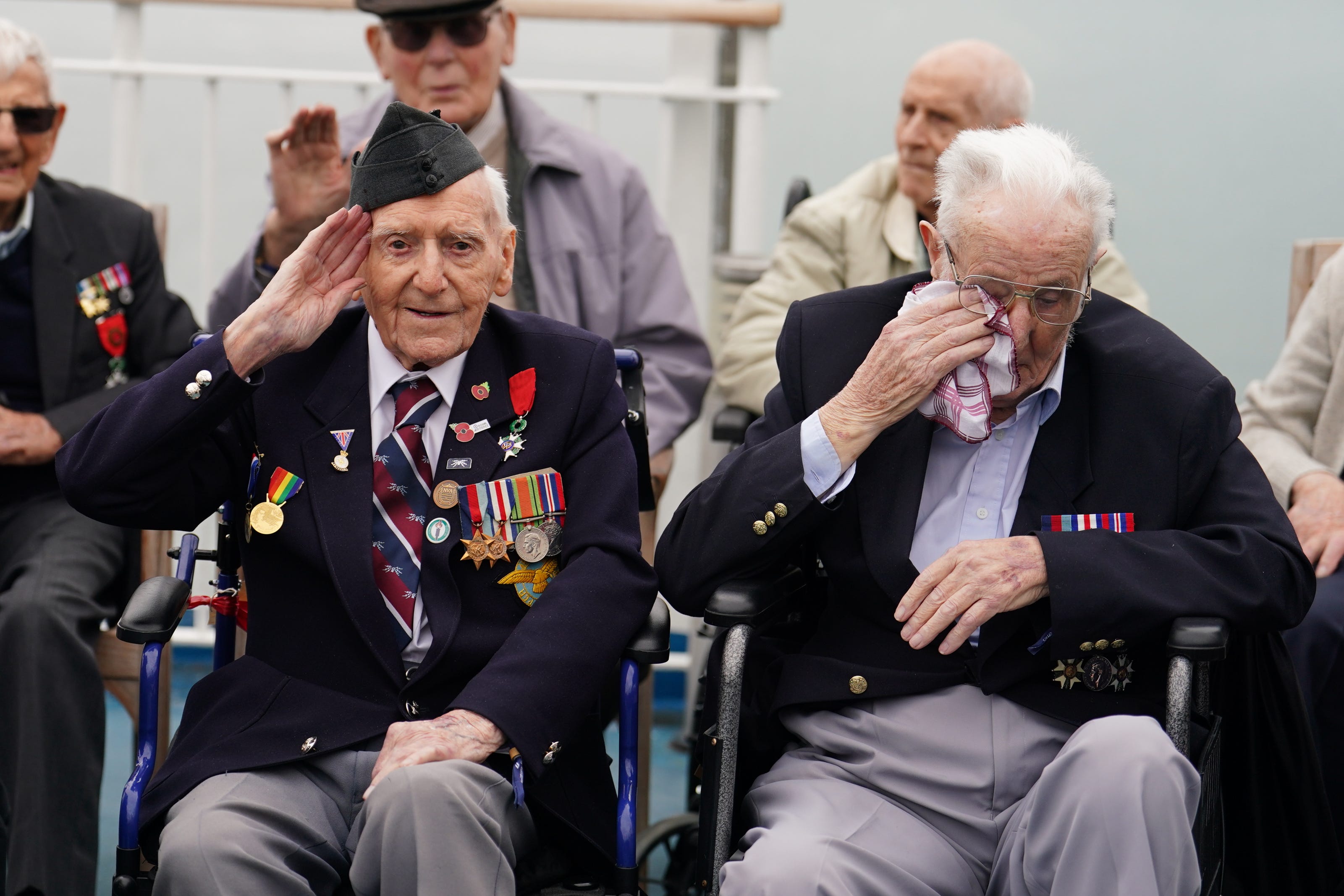 D-Day veteran Bernard Morgan (left), 100, from Crewe, salutes as Harry Birdsall, 98, from Wakefield, gets emotional as he travels on the Brittany Ferries ship Mont St Michel out of Portsmouth Harbour (Jordan Pettitt/PA)