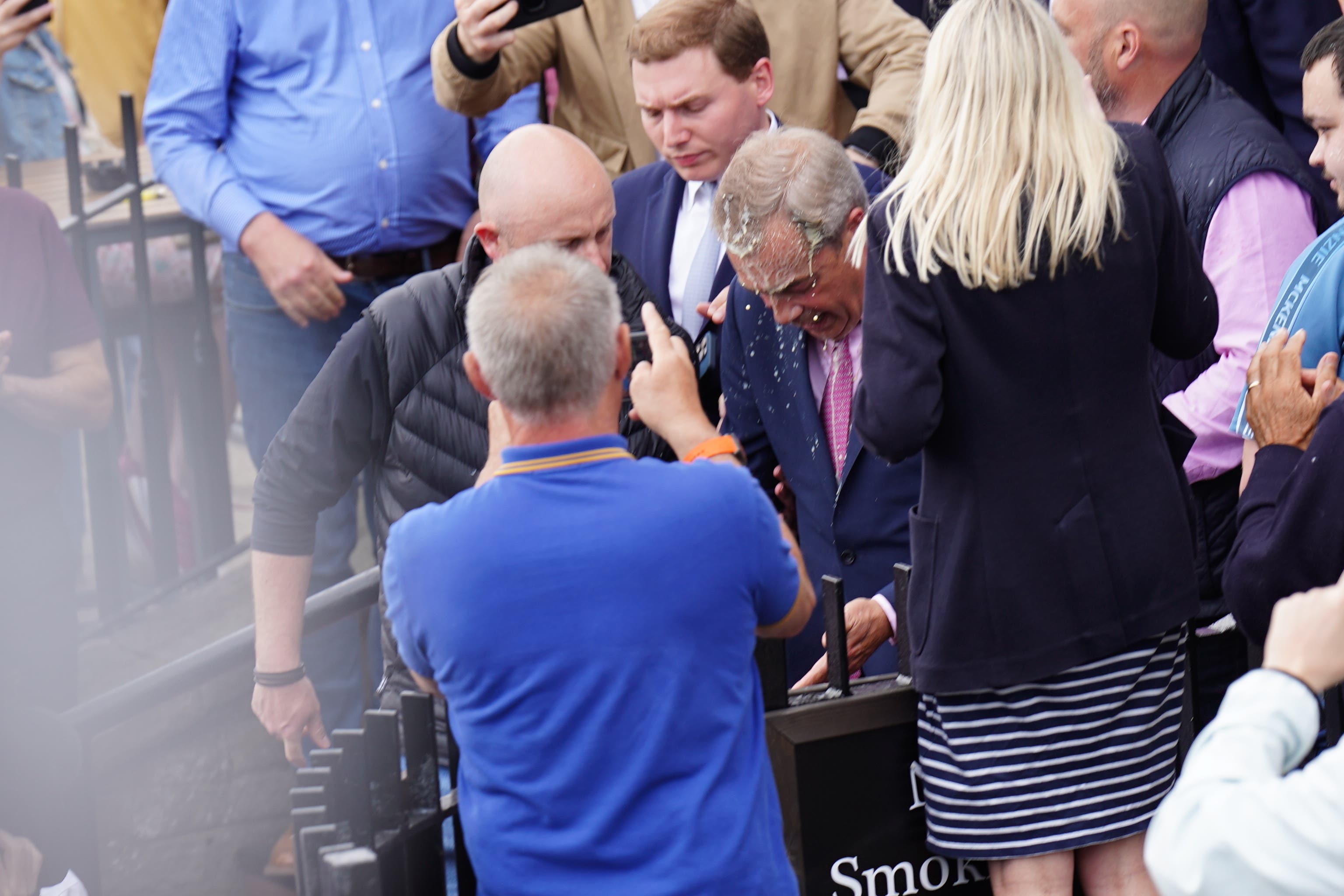 Leader of Reform UK Nigel Farage has a drink thrown over him as he leaves the Moon and Starfish pub (James Manning/PA)