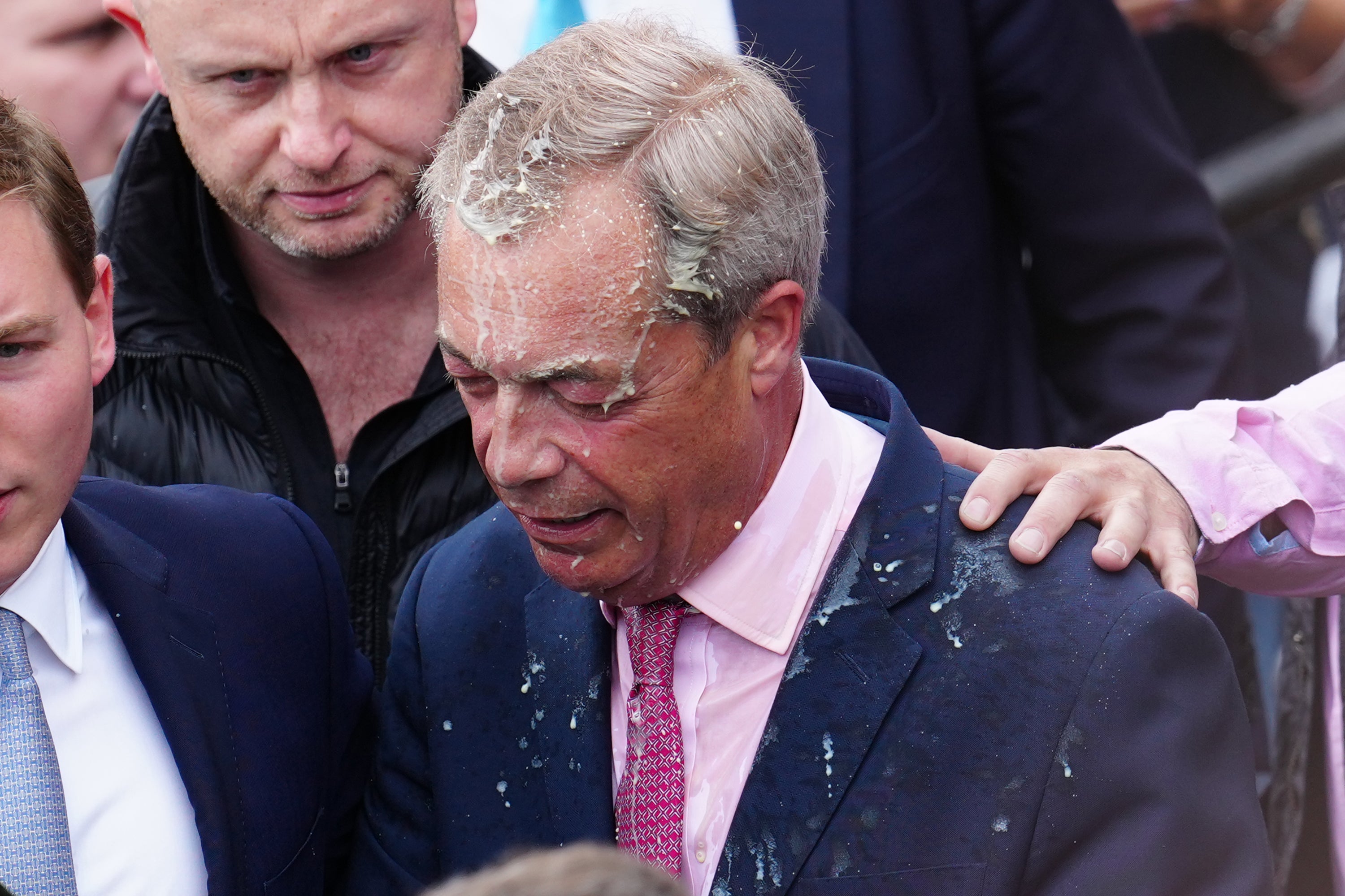 The milkshake could be seen splattered over his suit as he boarded his campaign bus