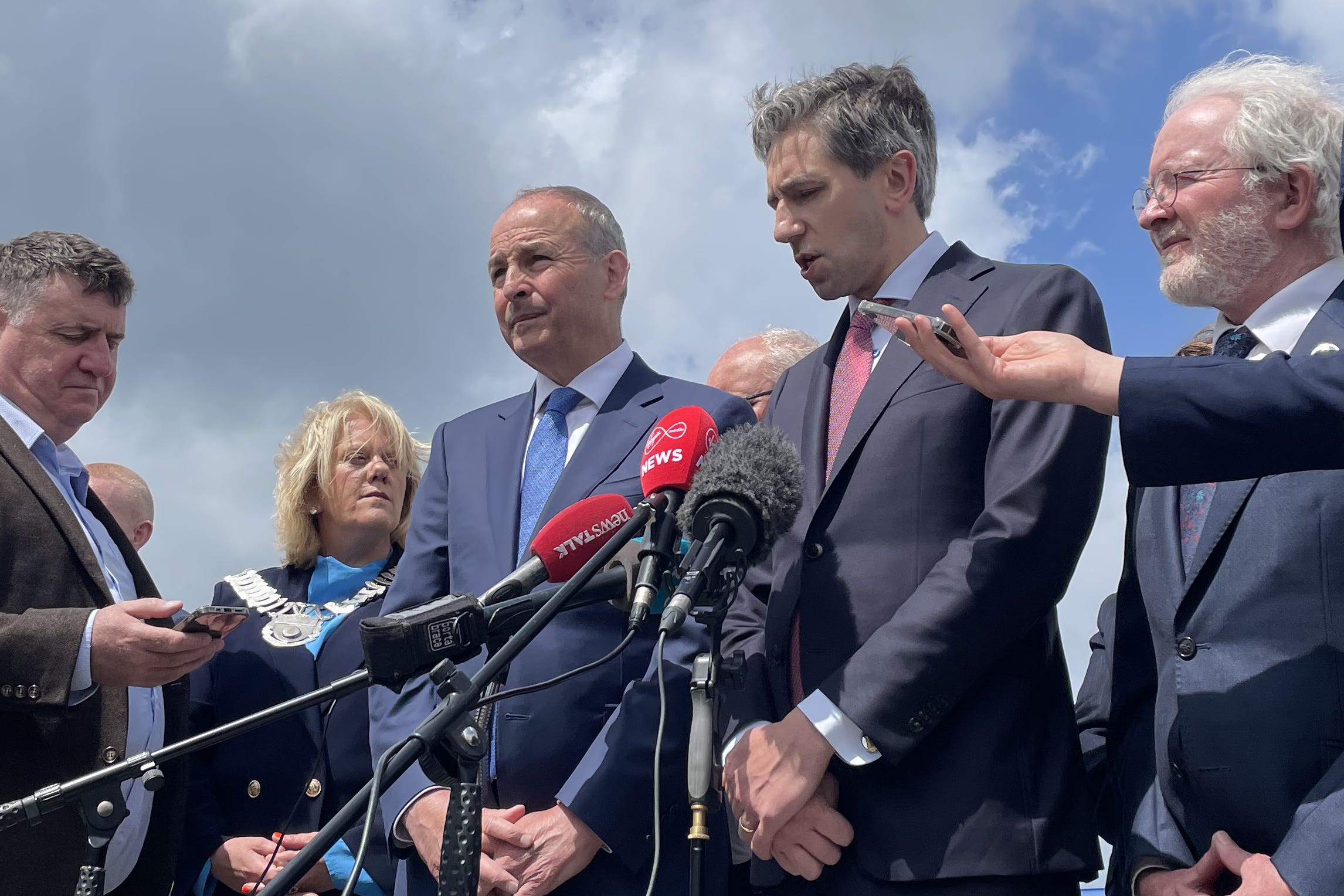 Ireland’s deputy premier, centre left, and premier Simon Harris, centre right, were speaking in Omeath, Co Louth (Grainne Ni Aodha/PA)