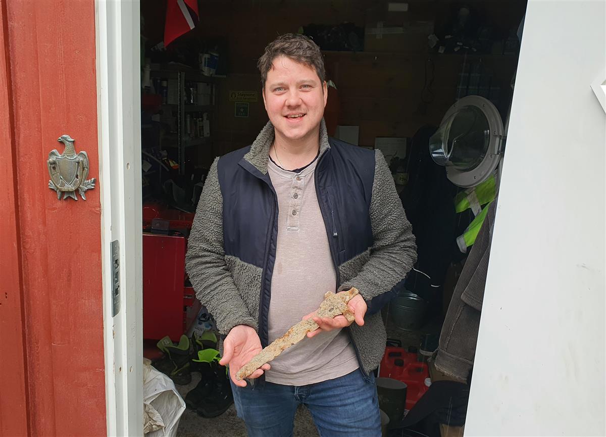 Man carrying ancient Viking sword