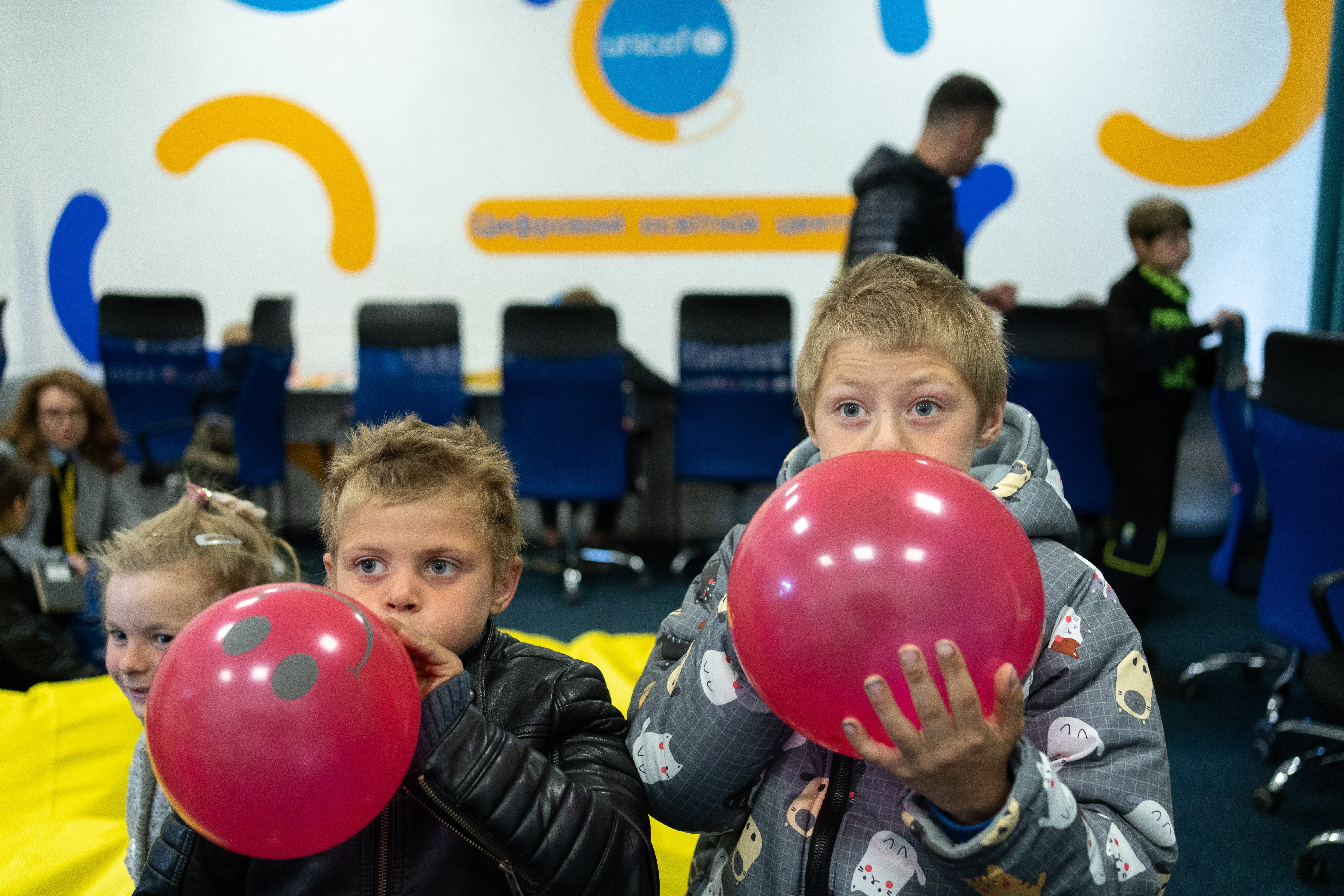 Iaroslav and his older brother Sasha blow up balloons in the children’s playroom of the Kharkiv transit centre