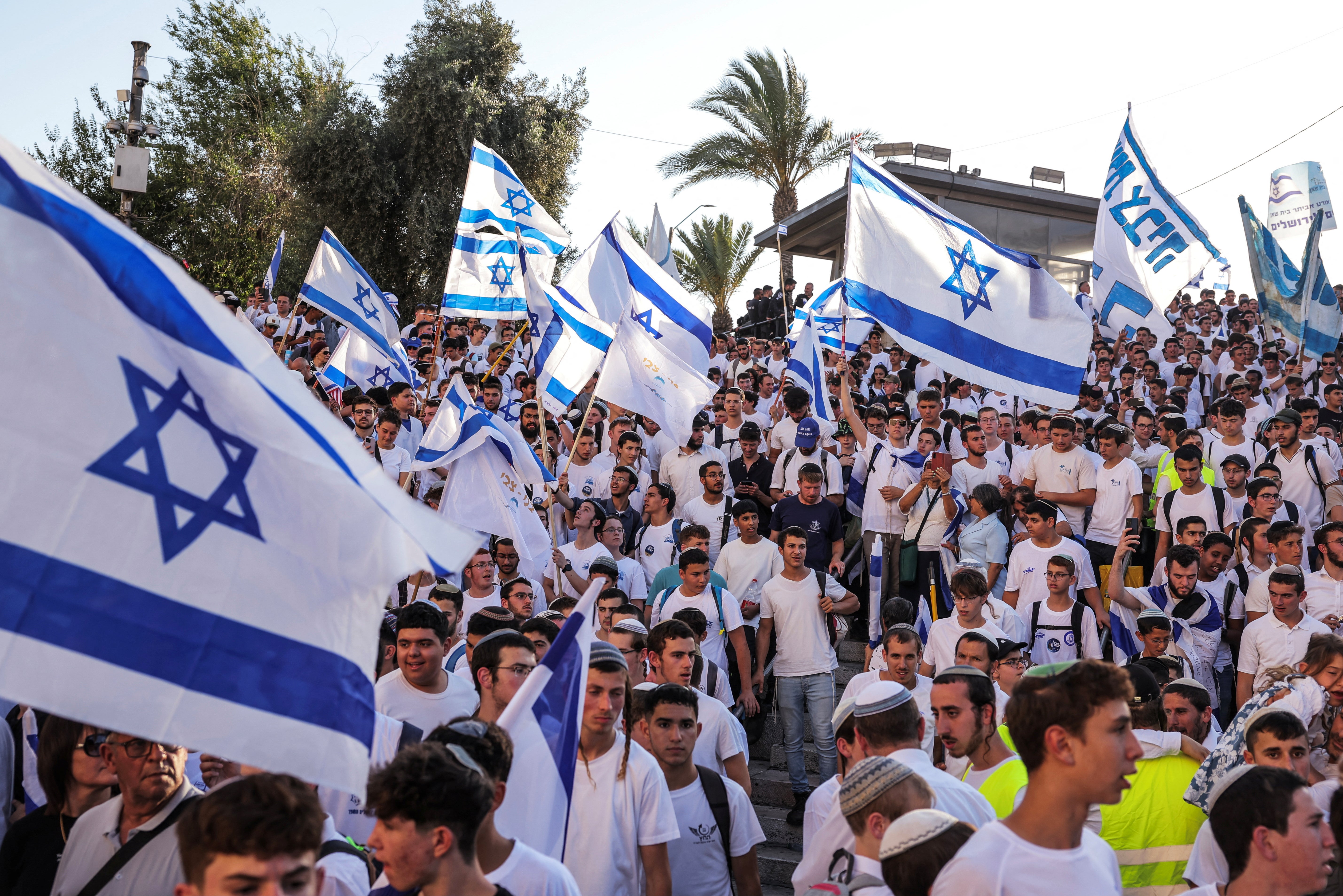 Israelis wave flags as they participate in the march