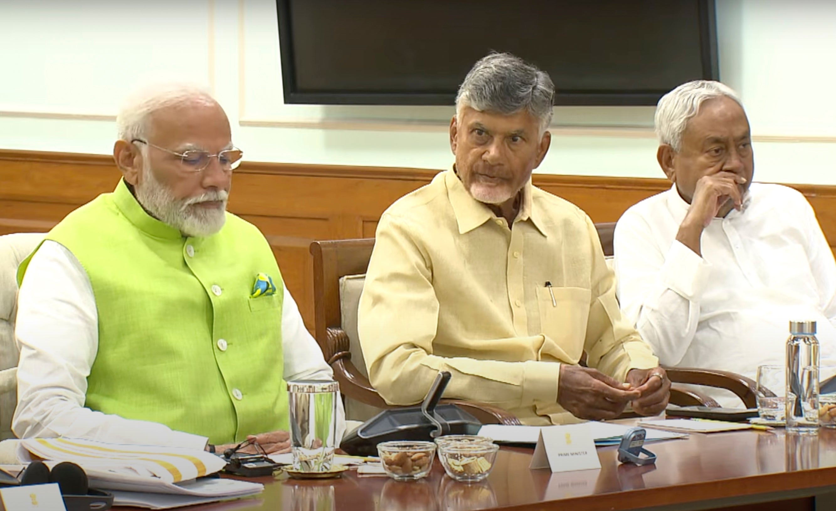 Indian prime minister elect Narendra Modi, left, is sitting next to Telugu Desam Party leader N Chandrababu Naidu, center, and Janata Dal (United) leader Nitish Kumar.