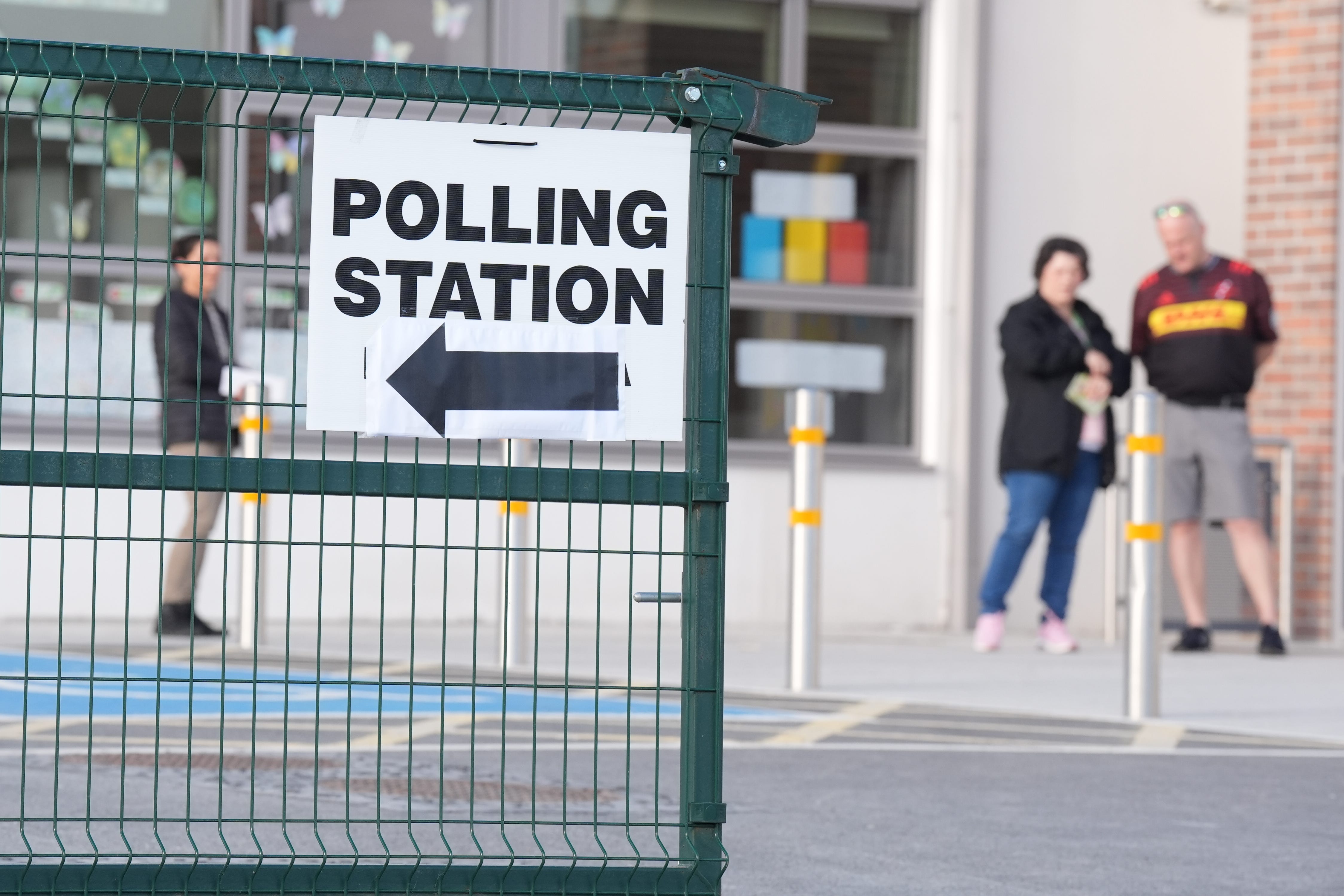 Early voters wait for the polling station to open so they can cast their votes in the local and European elections at Scoil Mhichil Naofa in Athy Co Kildare. Picture date: Friday June 7, 2024.