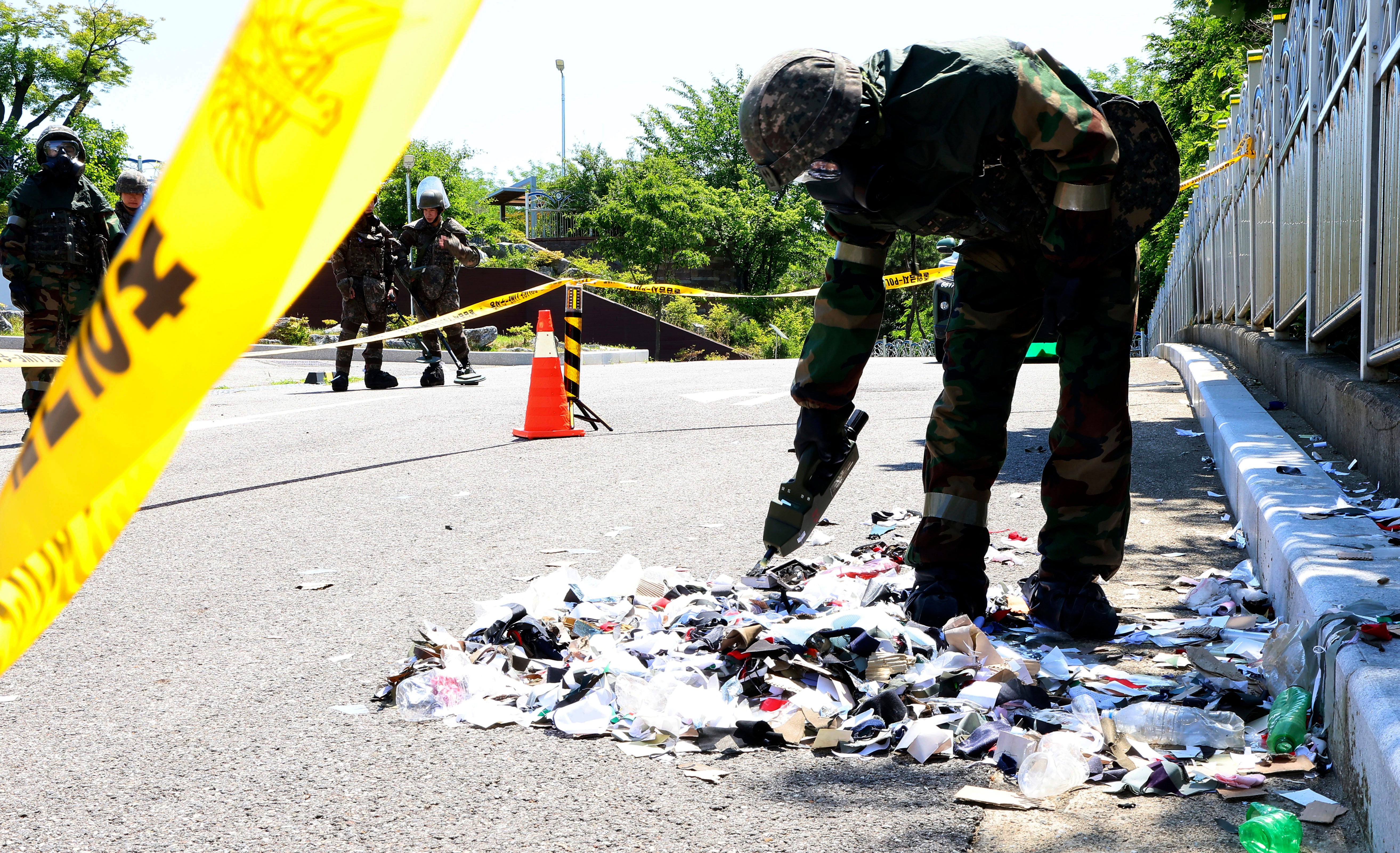 South Korean soldier wearing protective gears checks the trash from a balloon presumably sent by North Korea, in Incheon, South Korea, on 2 June 2024