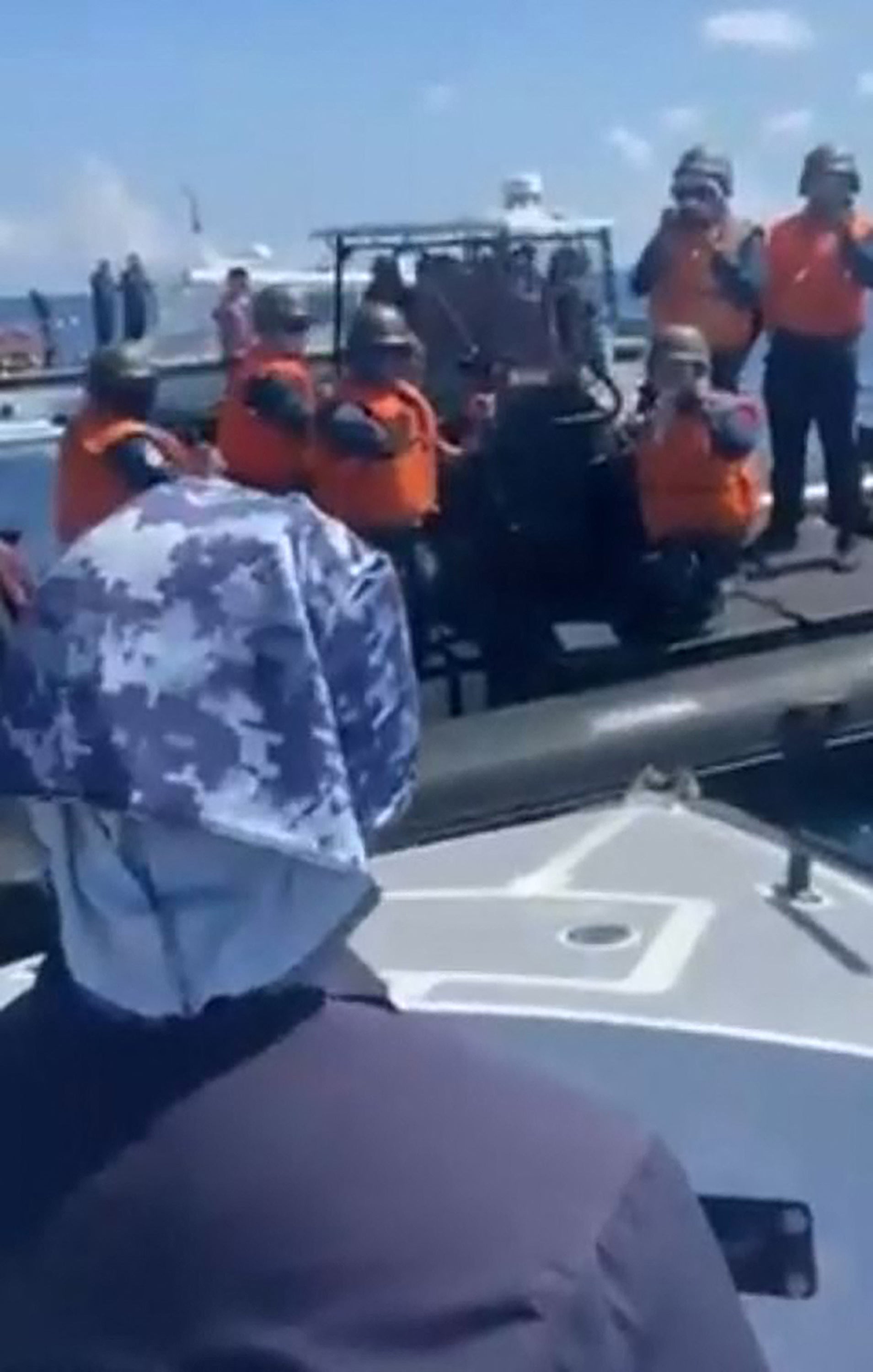 A photo released by the Philippine coast guard shows a Chinese inflatable boat blocking a Philippine vessel on a medical evacuation in the South China Sea