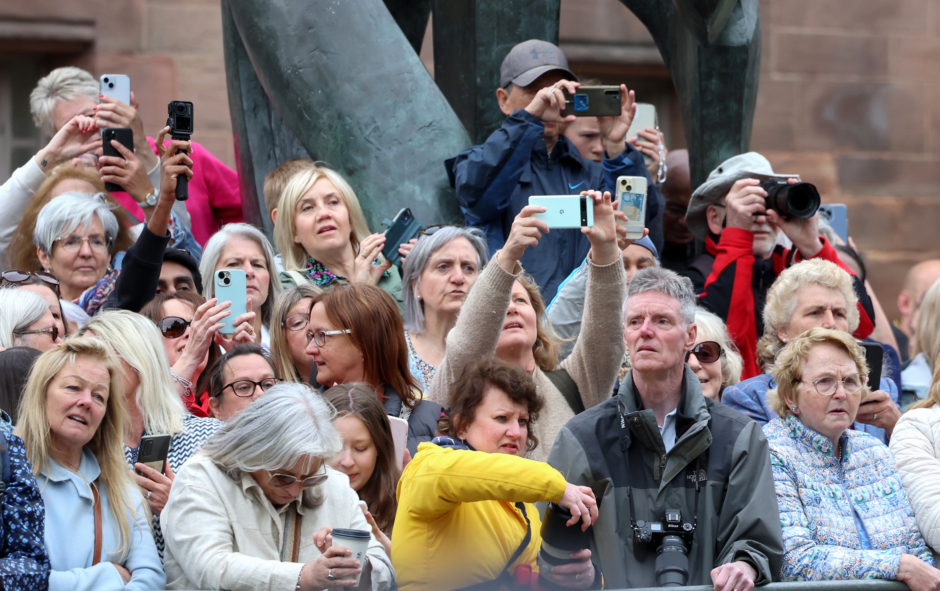 Crowds waited patiently during the service to wait for the couple to come outside and share their kiss