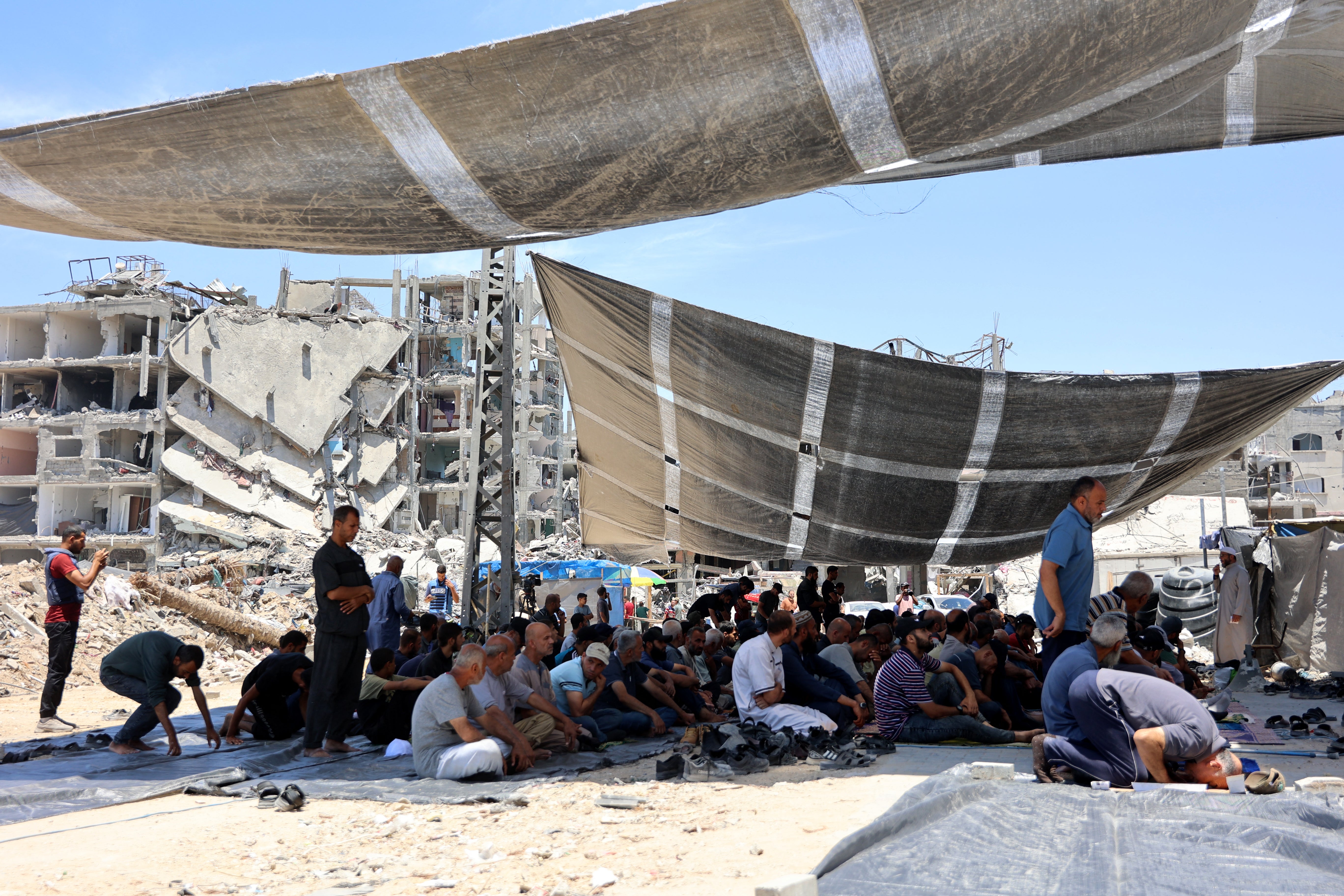 Palestinian men take part in Friday noon prayers in the Jabalia refugee camp, in the northern Gaza Strip