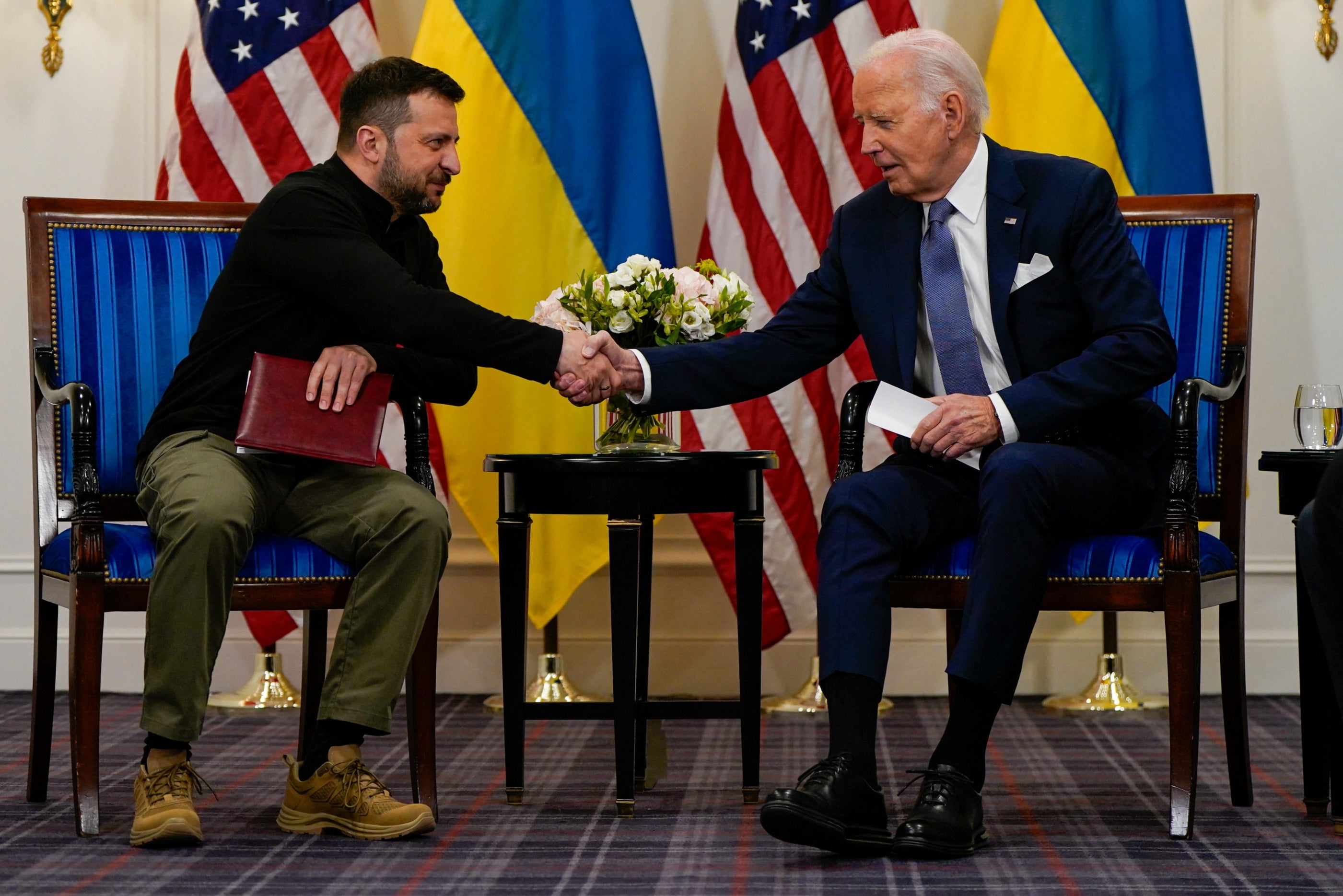 Joe Biden shakes hands with Volodymyr Zelensky in Paris