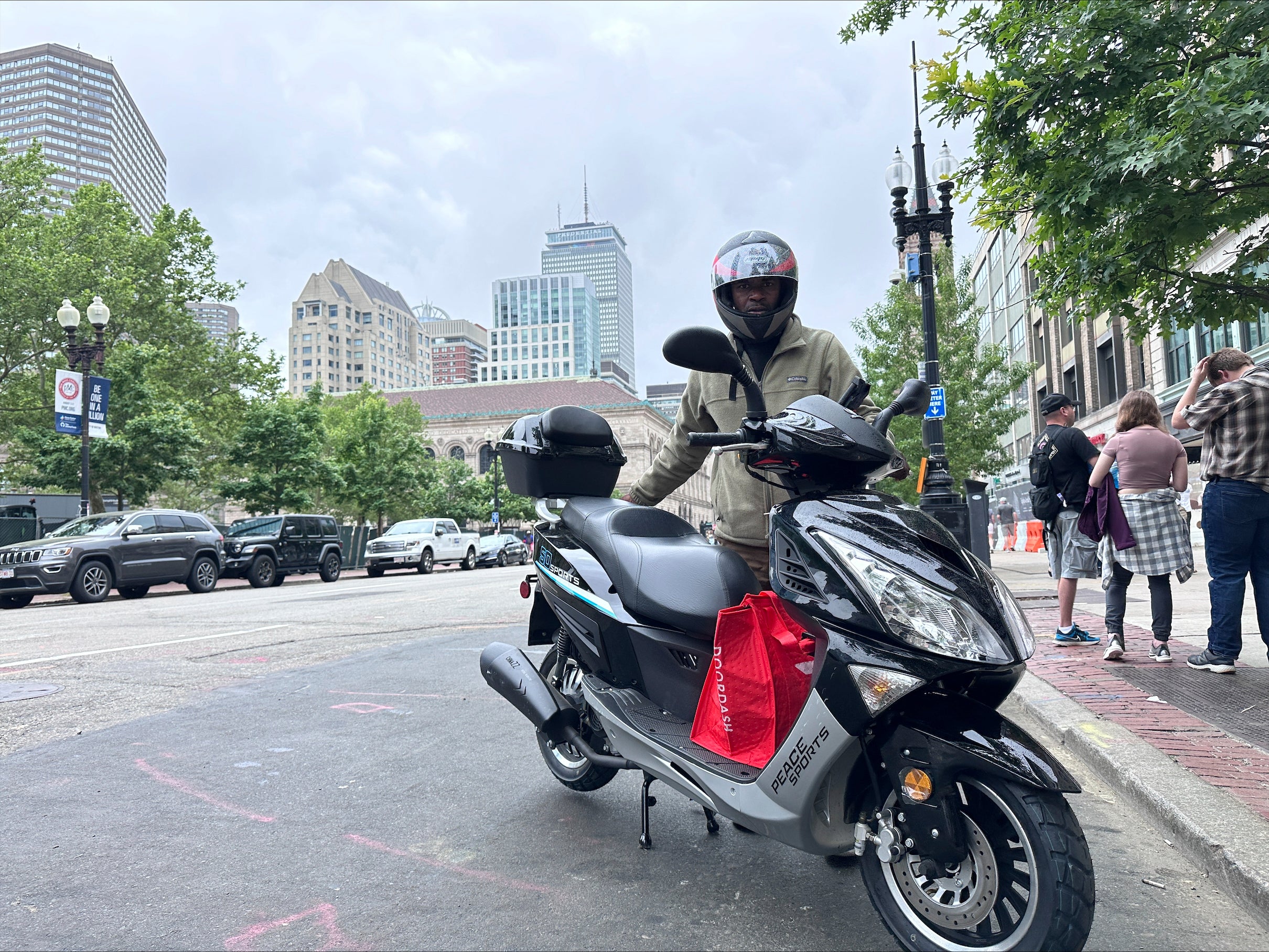 Delivery scooters are parked as drivers wait to pick up food for delivery, Thursday, June 6, 2024, in Boston