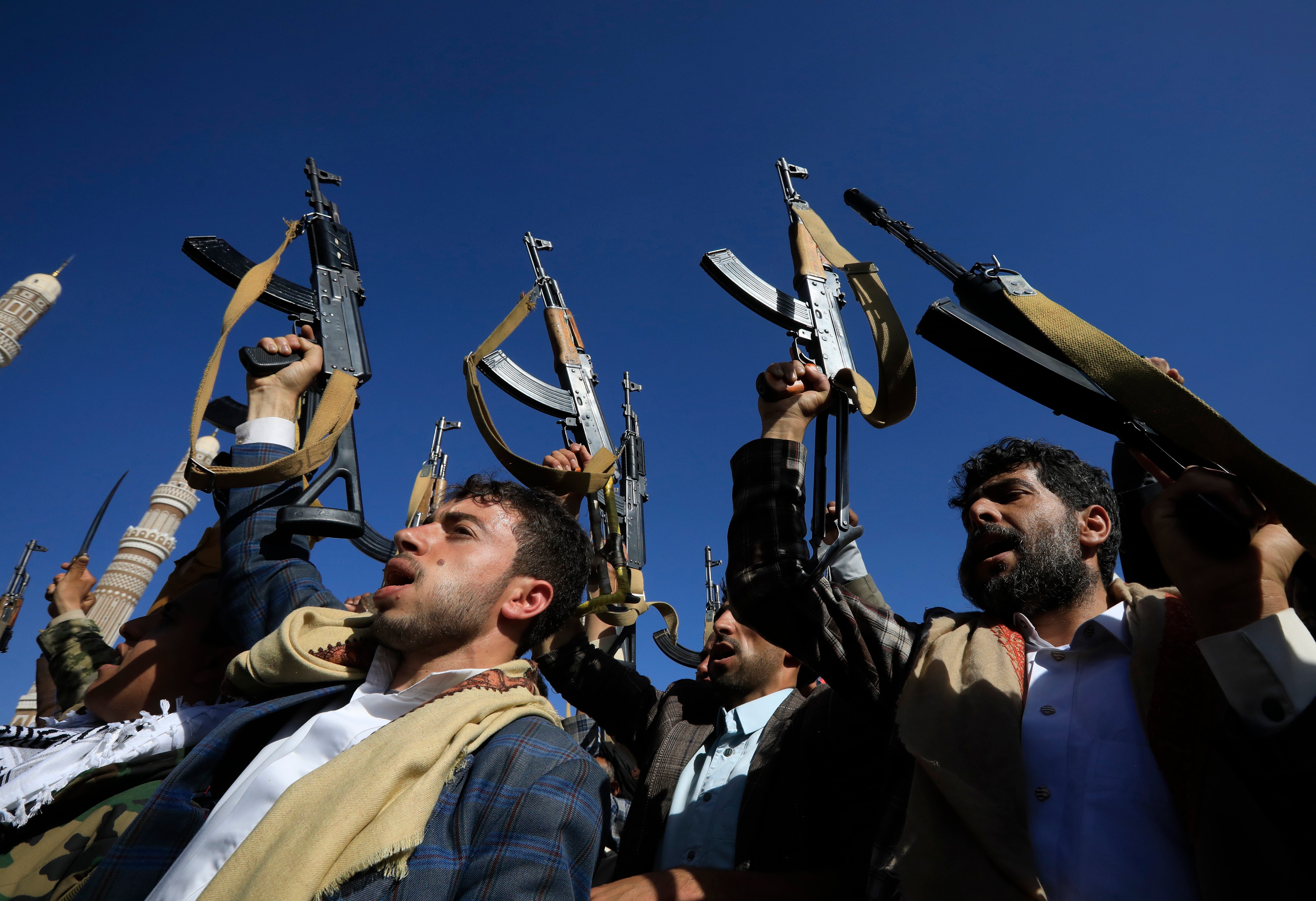 Houthi supporters chant slogans while holding up weapons during a protest against the US and Israel, and in solidarity with the Palestinian people, in Sana'a, Yemen