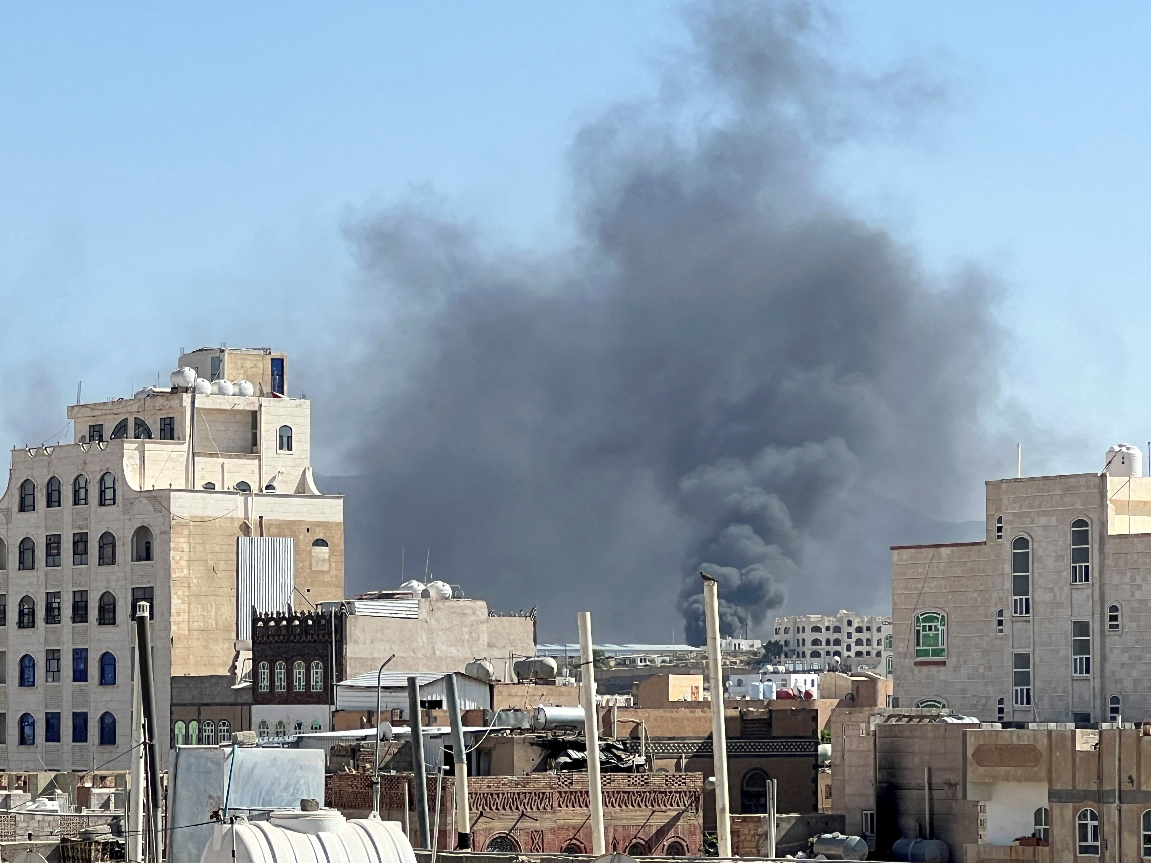 Plumes of smoke rise from what is thought to be the site of an airstrike in Sanaa, Yemen