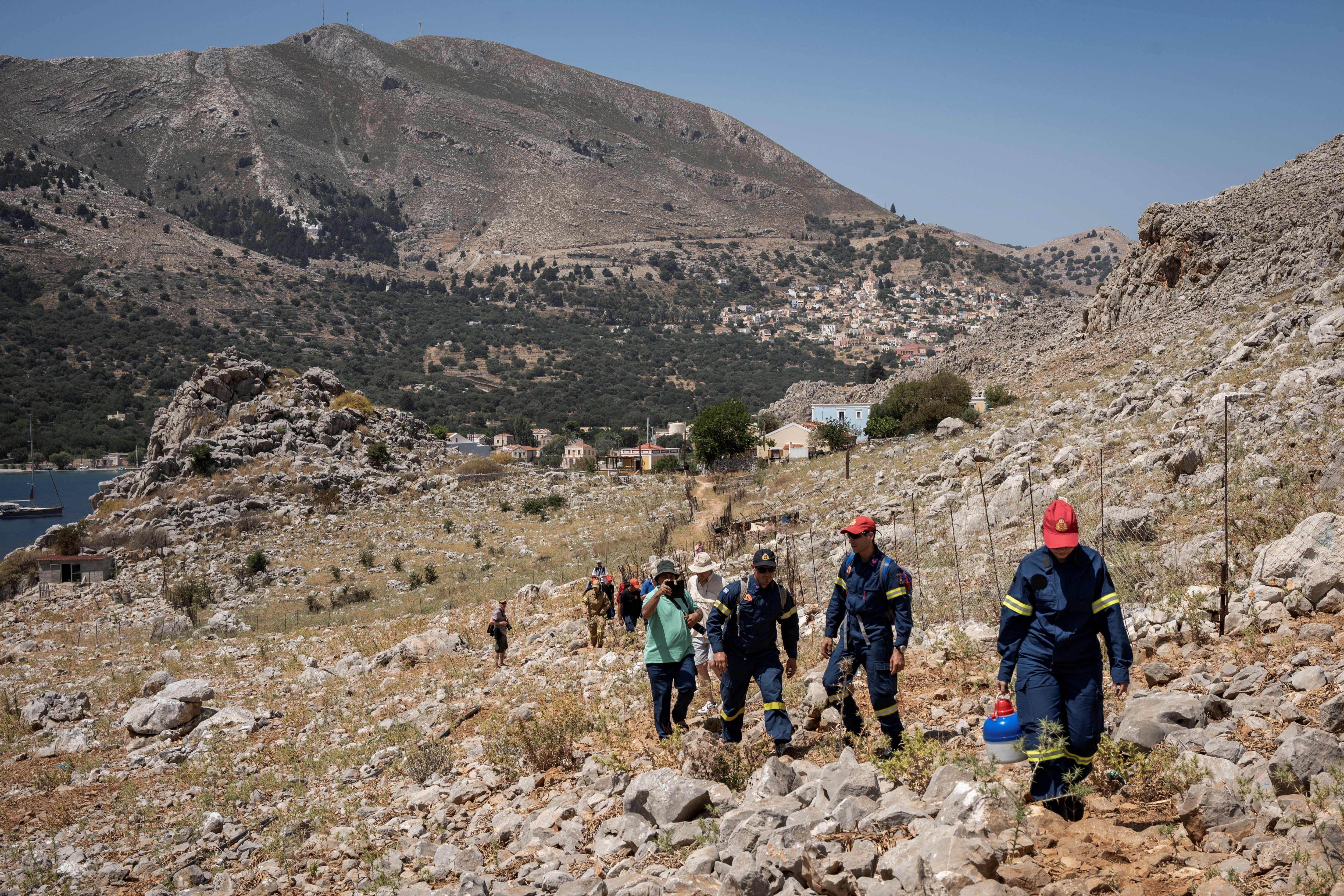 Firefighters take part in a search and rescue operation for Michael Mosley in Symi, Greece