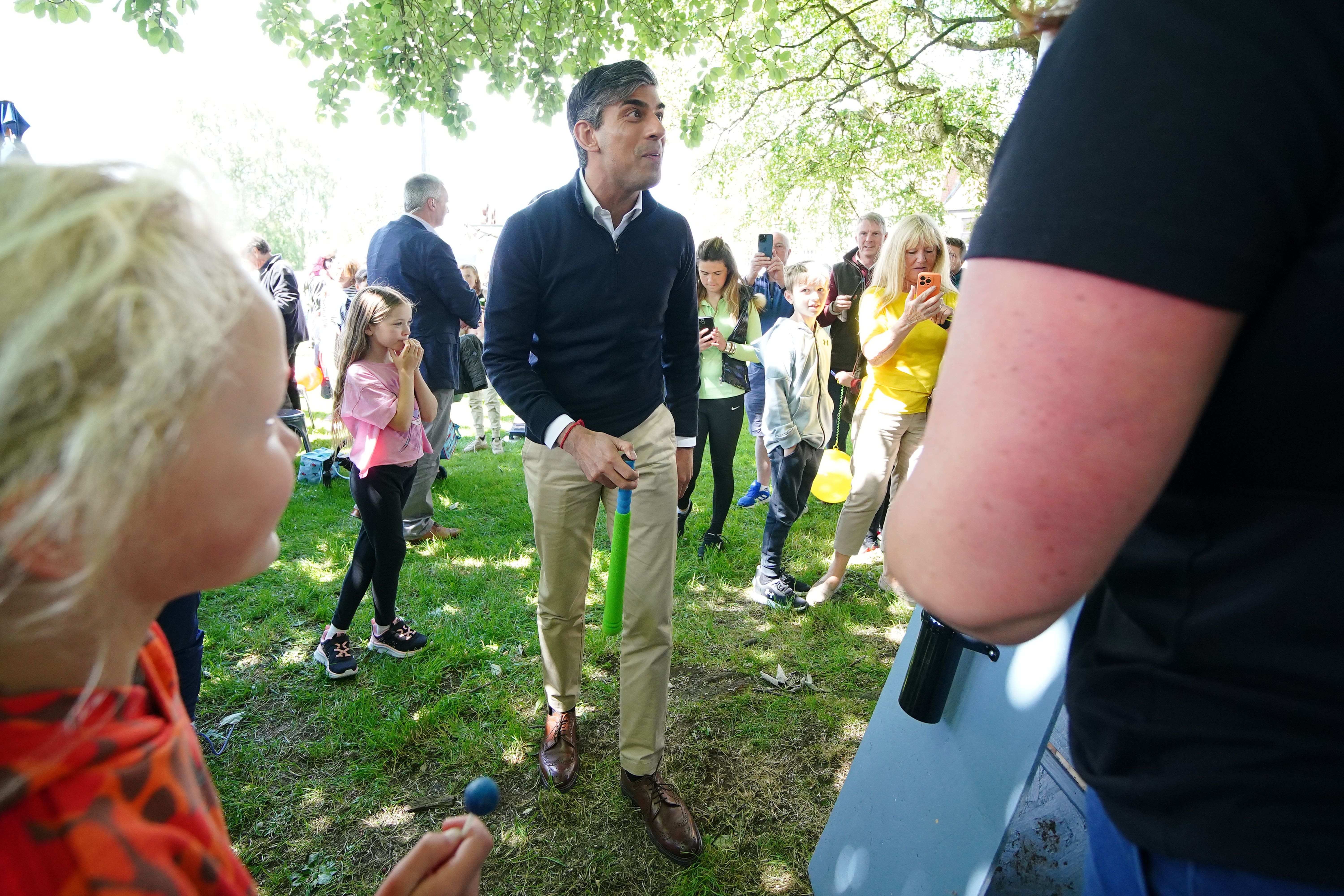 Prime Minister Rishi Sunak talking to a person at a village fete (PA)