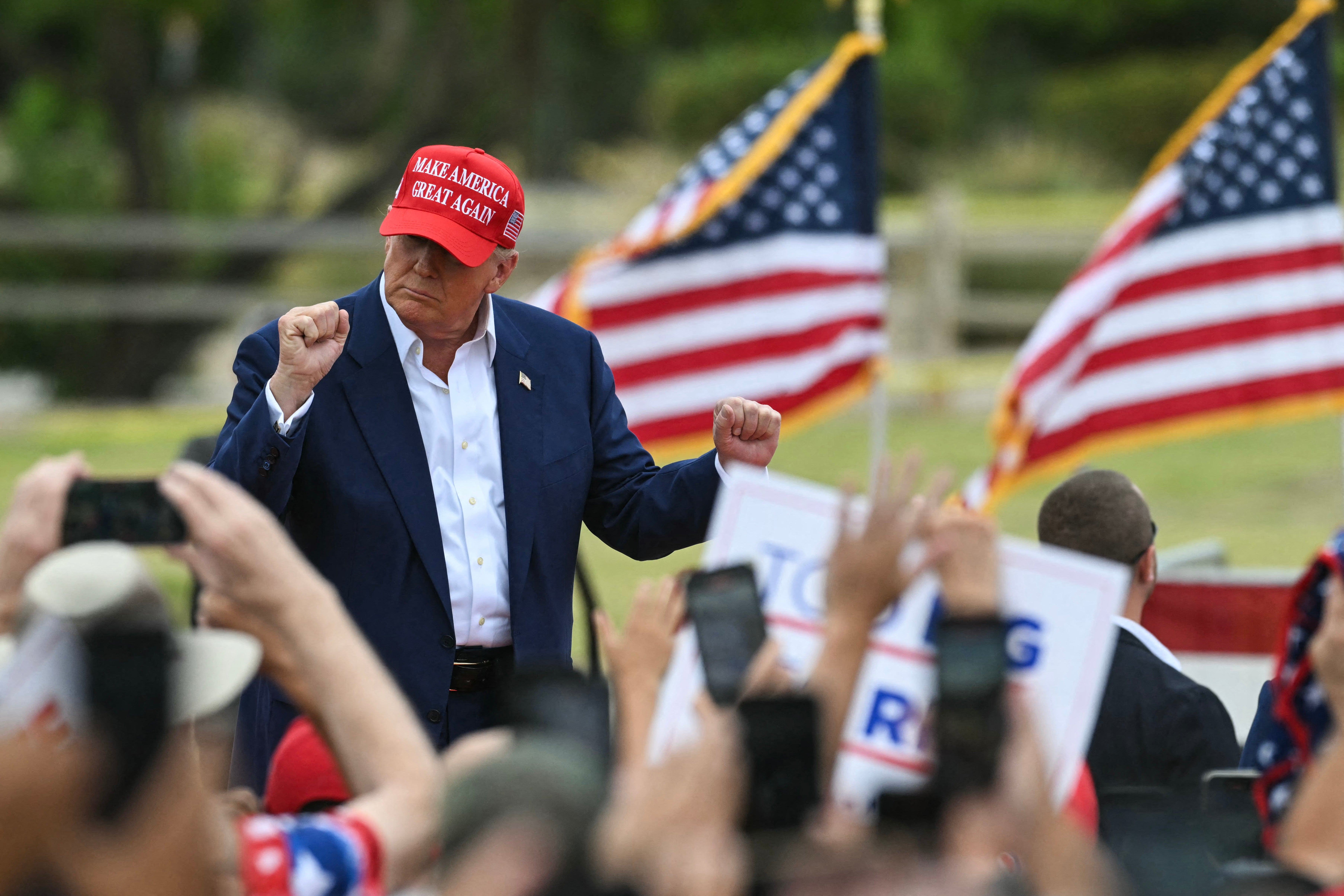 Former US President and Republican presidential candidate Donald Trump arrives onstage to speak during a campaign rally at Sunset Park in Las Vegas, Nevada on June 9, 2024