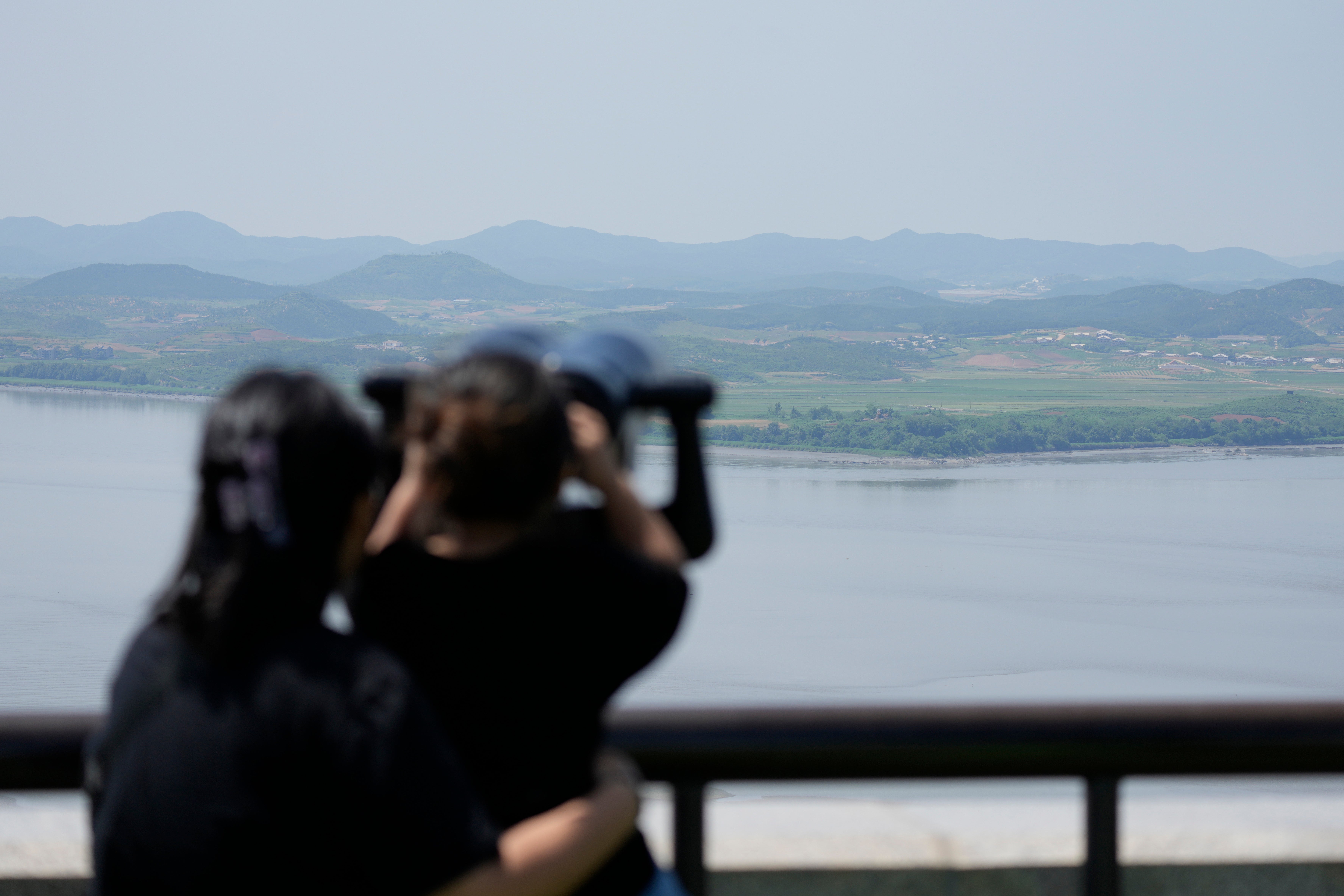 Visitors use binoculars to see the North Korean side from the unification observatory in Paju, South Korea