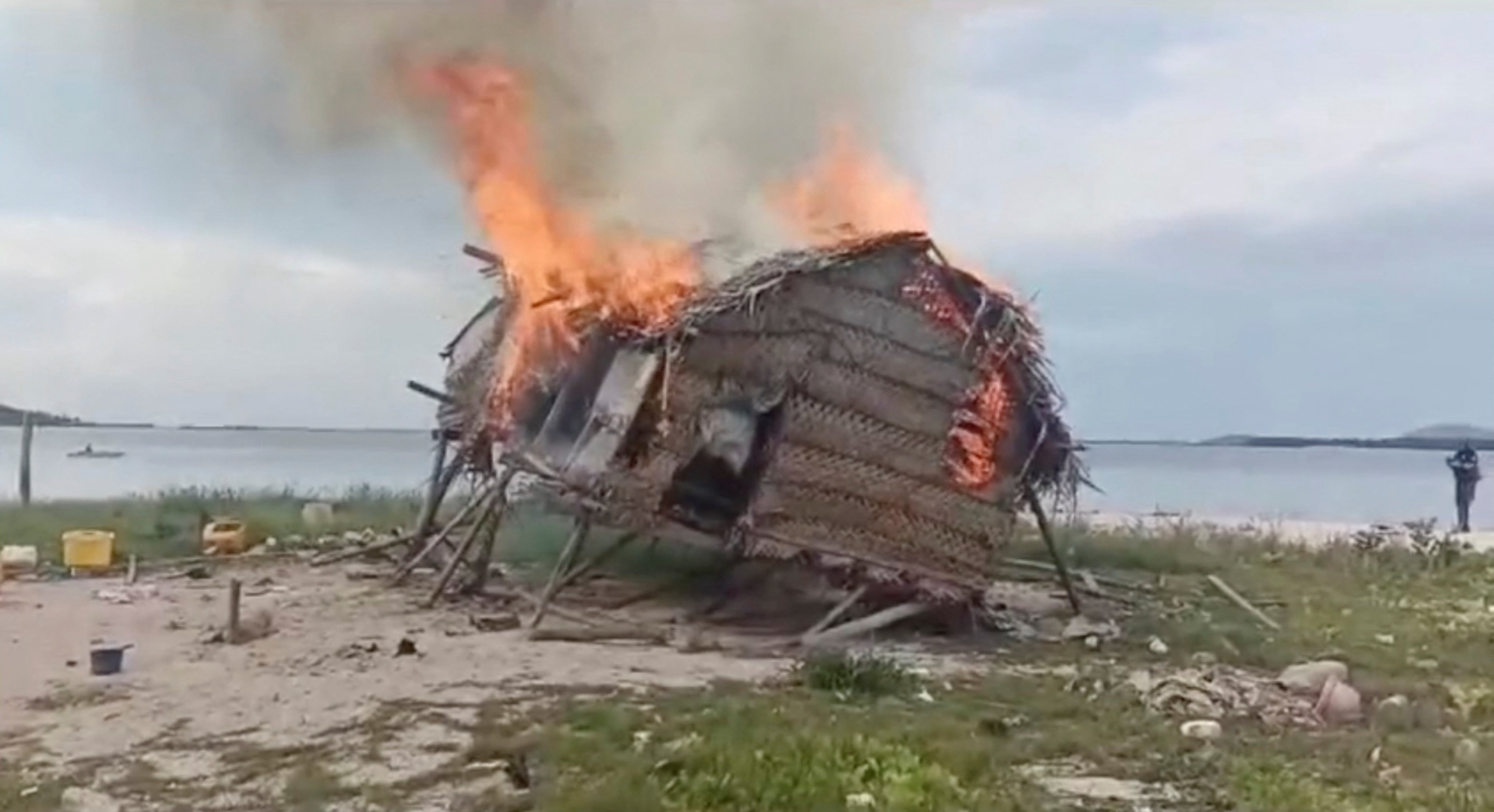 Smoke rises as a house is demolished in Tun Sakaran Marine Park, Sabah, Malaysia, in this screen grab obtained from a social media video, released on June 4, 2024