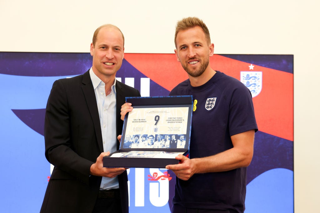 Prince William, Prince of Wales, presents England captain Harry Kane with a legacy shirt