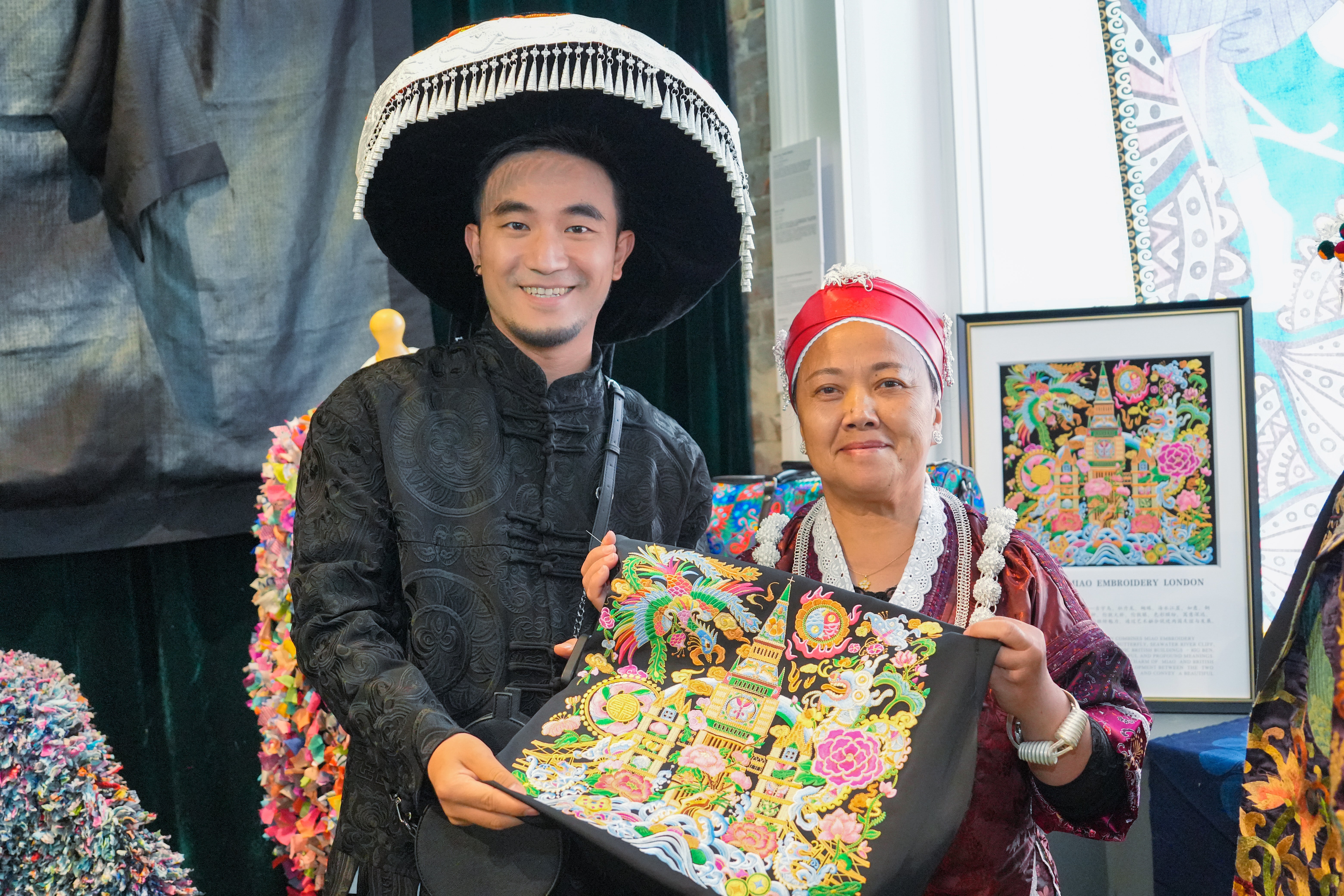 Miao ethnic designer Yang Chunlin and his mother Yang Shiying showcase a representation of the Big Ben at an exhibition during the 10th London Craft Week in May