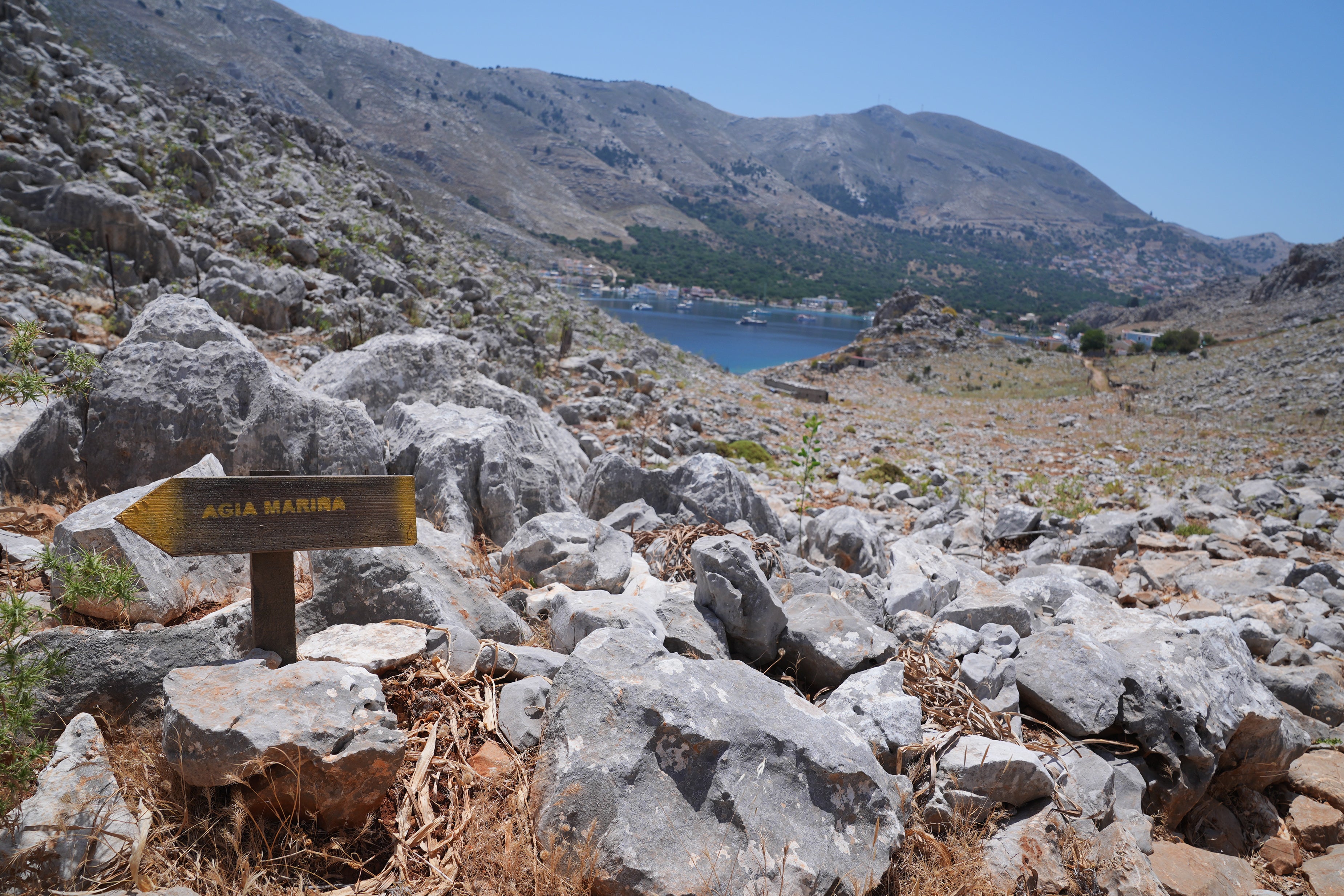 A direction sign on a rocky path in the hills of Pedi pointing toward Agia Marina, where the TV doctor’s body was discovered