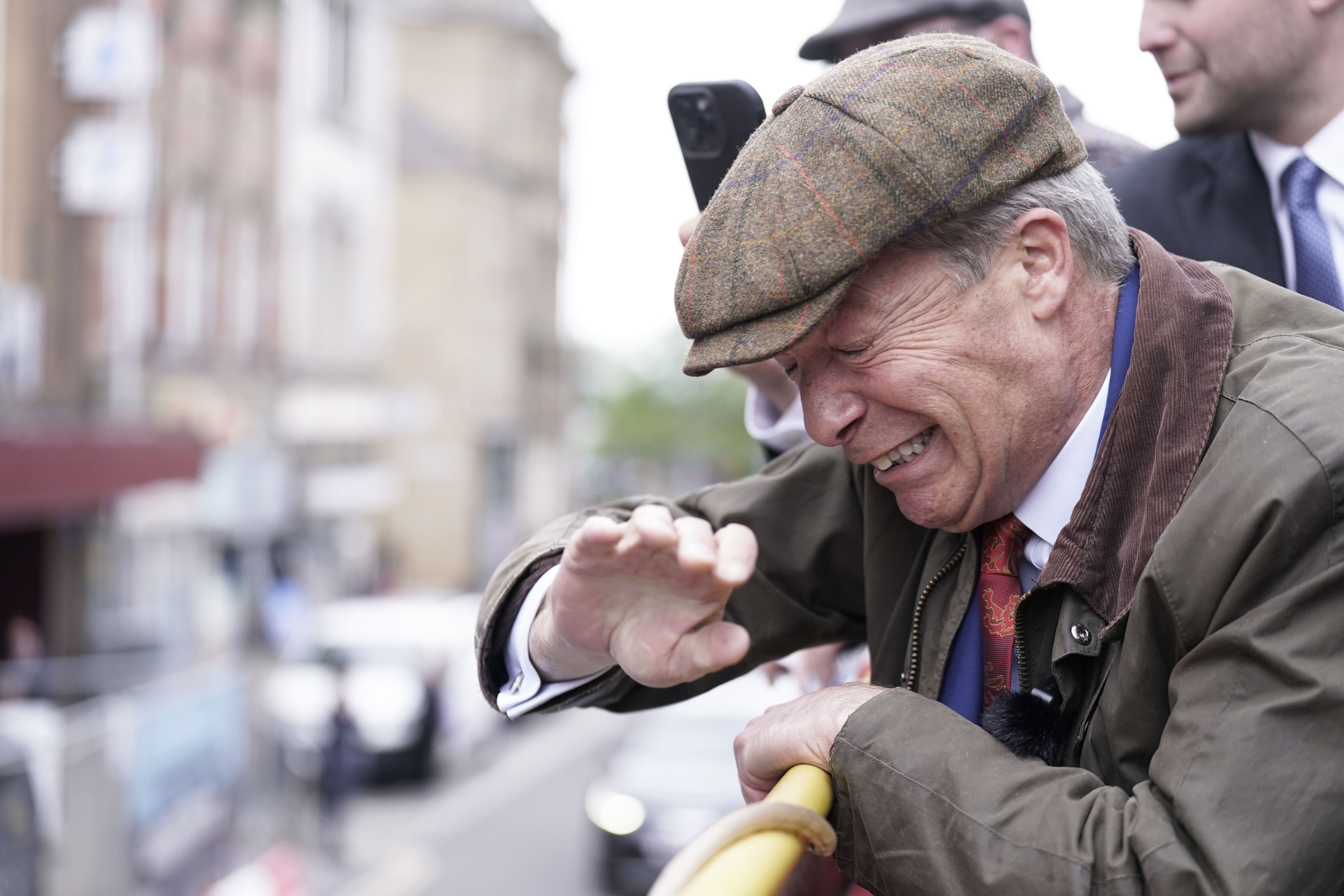 Reform UK leader Nigel Farage reacts after an object is thrown towards him on the Reform UK campaign bus (Danny Lawson/PA)