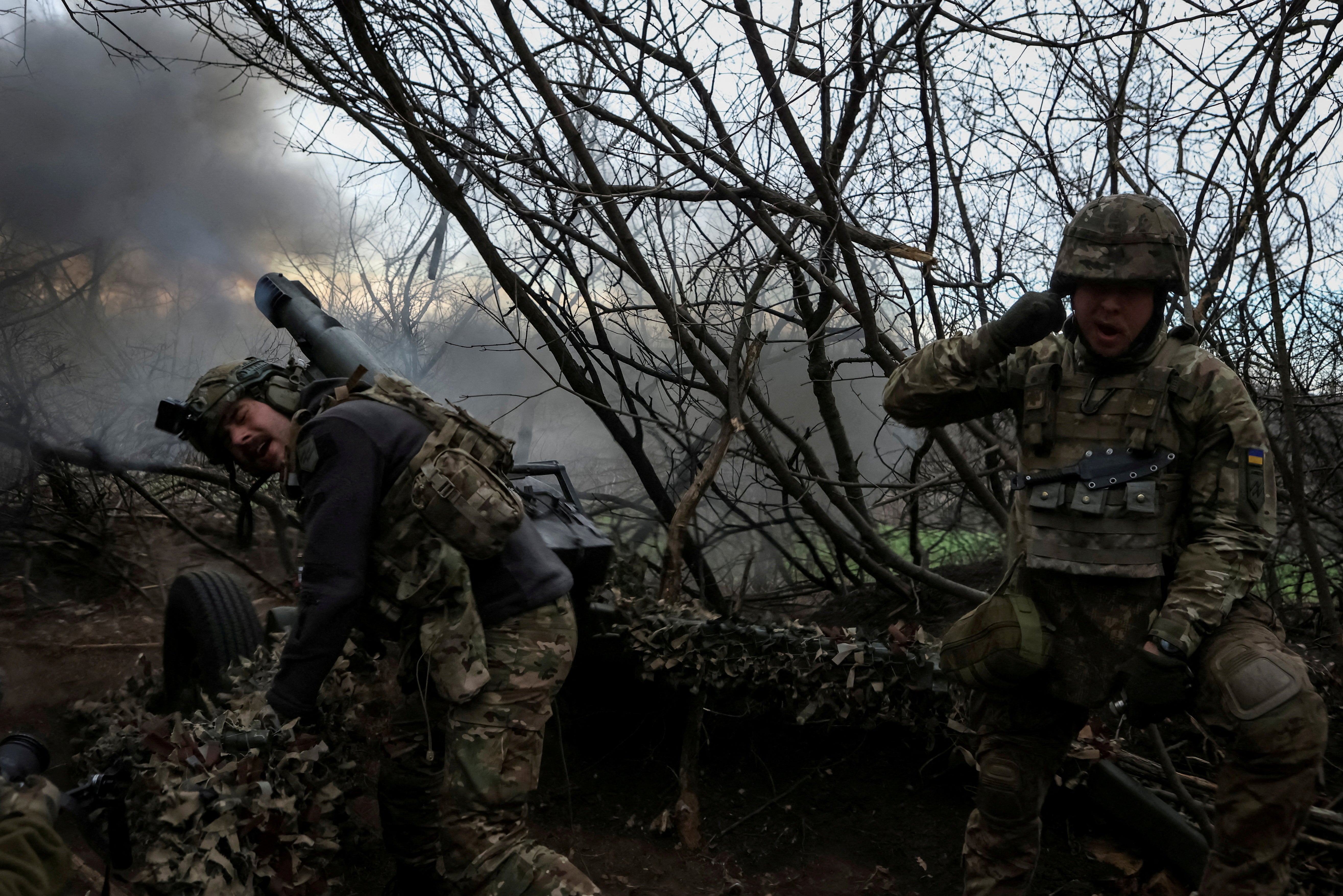 Servicemen fire a howitzer towards Russian troops in the Donetsk region