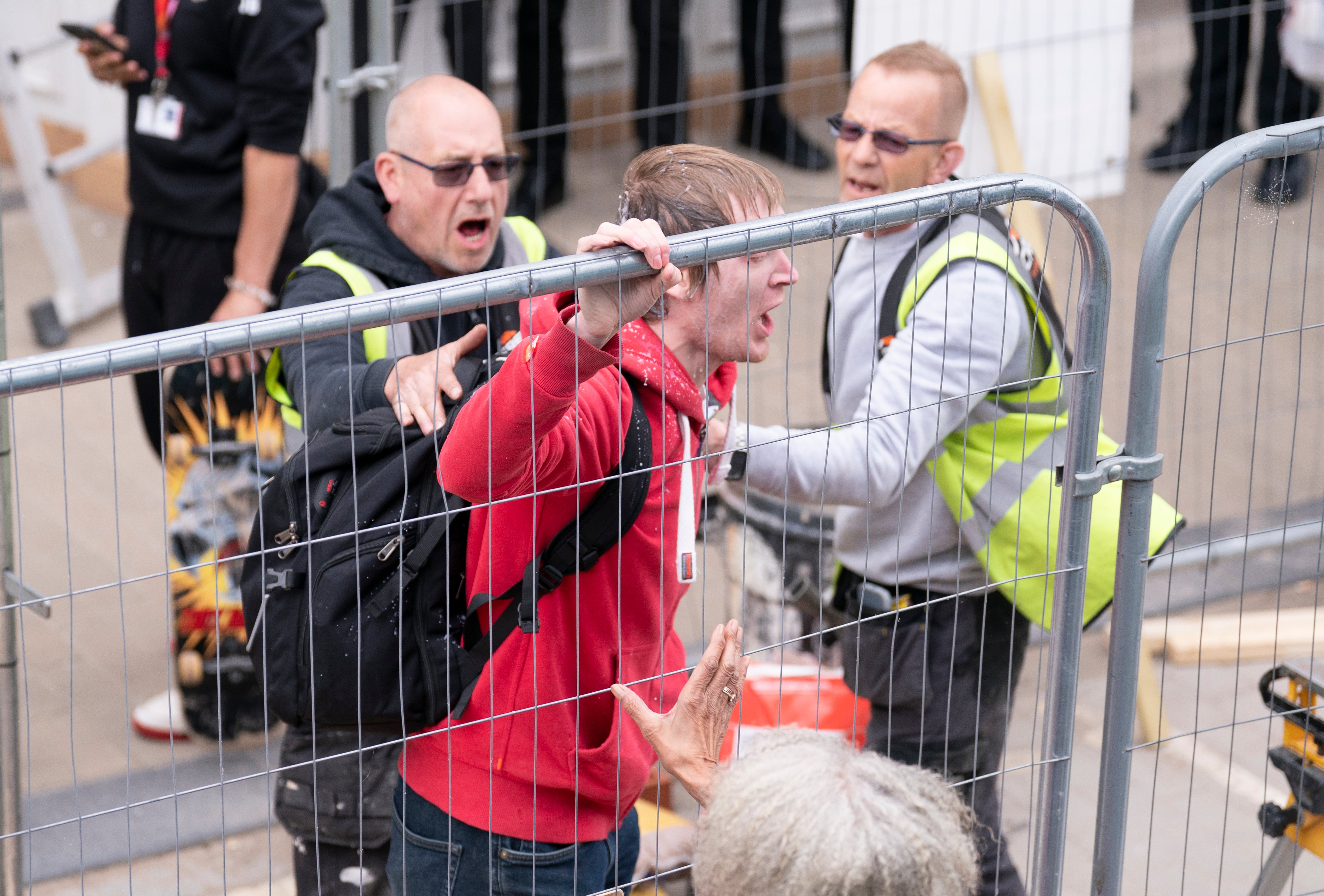 Greally was caught on camera being pulled away from the scene by builders