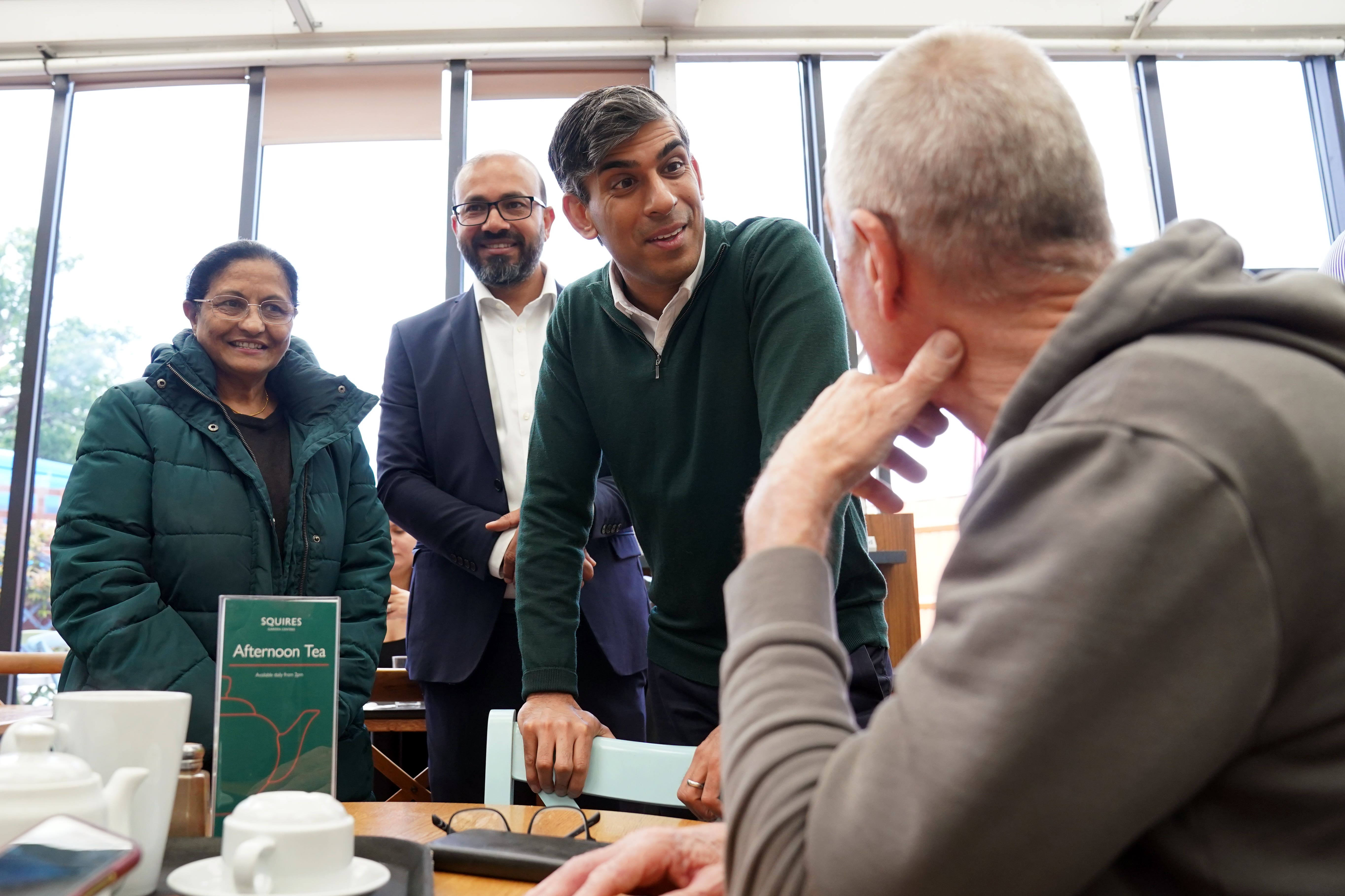 Prime Minister Rishi Sunak talking to locals at a cafe in Squires Garden Centre in Crawley, West Sussex (Gareth Fuller/PA)