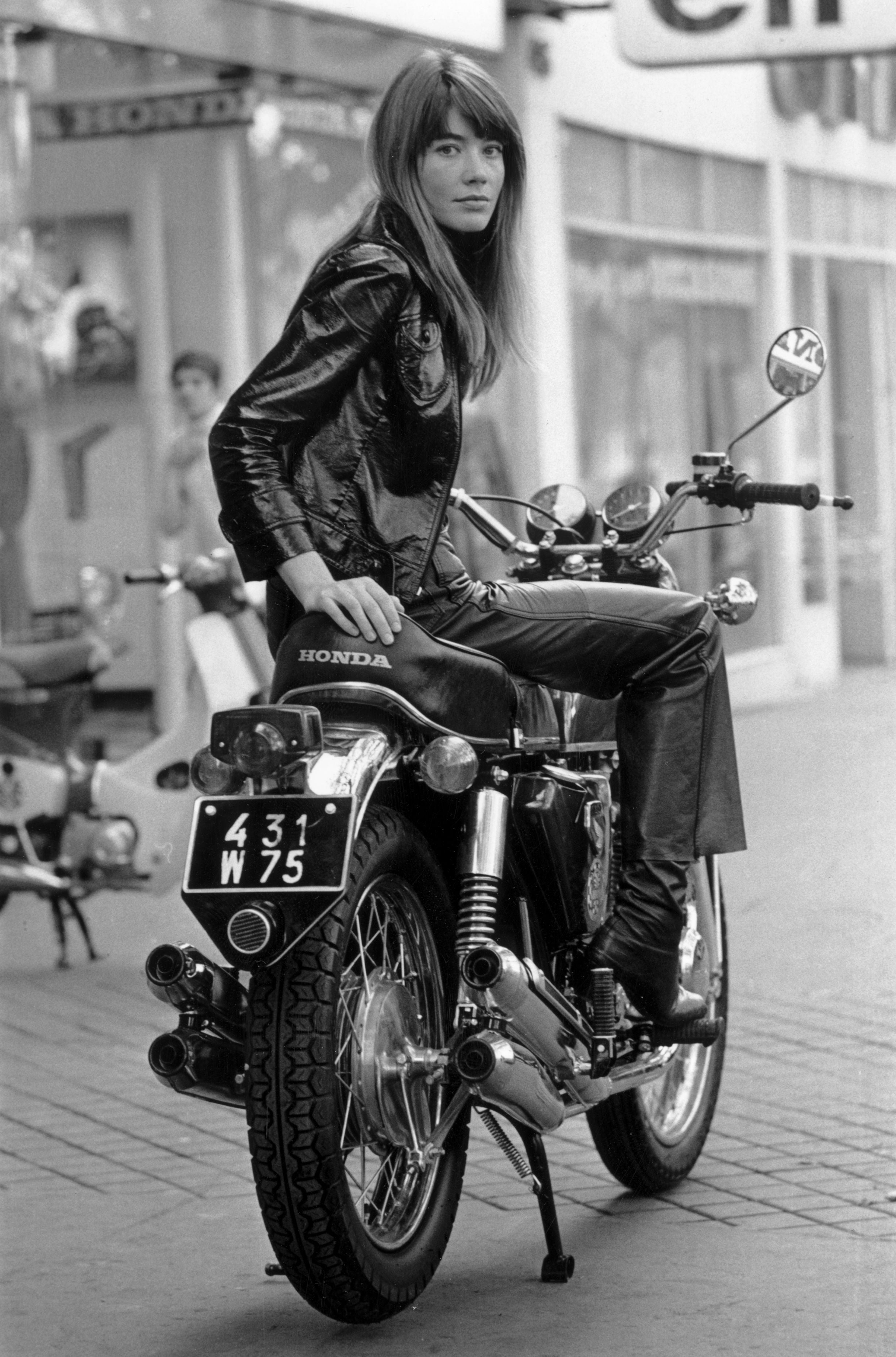 French singer, Francoise Hardy sitting on a Honda CB750 motorcycle, Paris, 25th October 1969