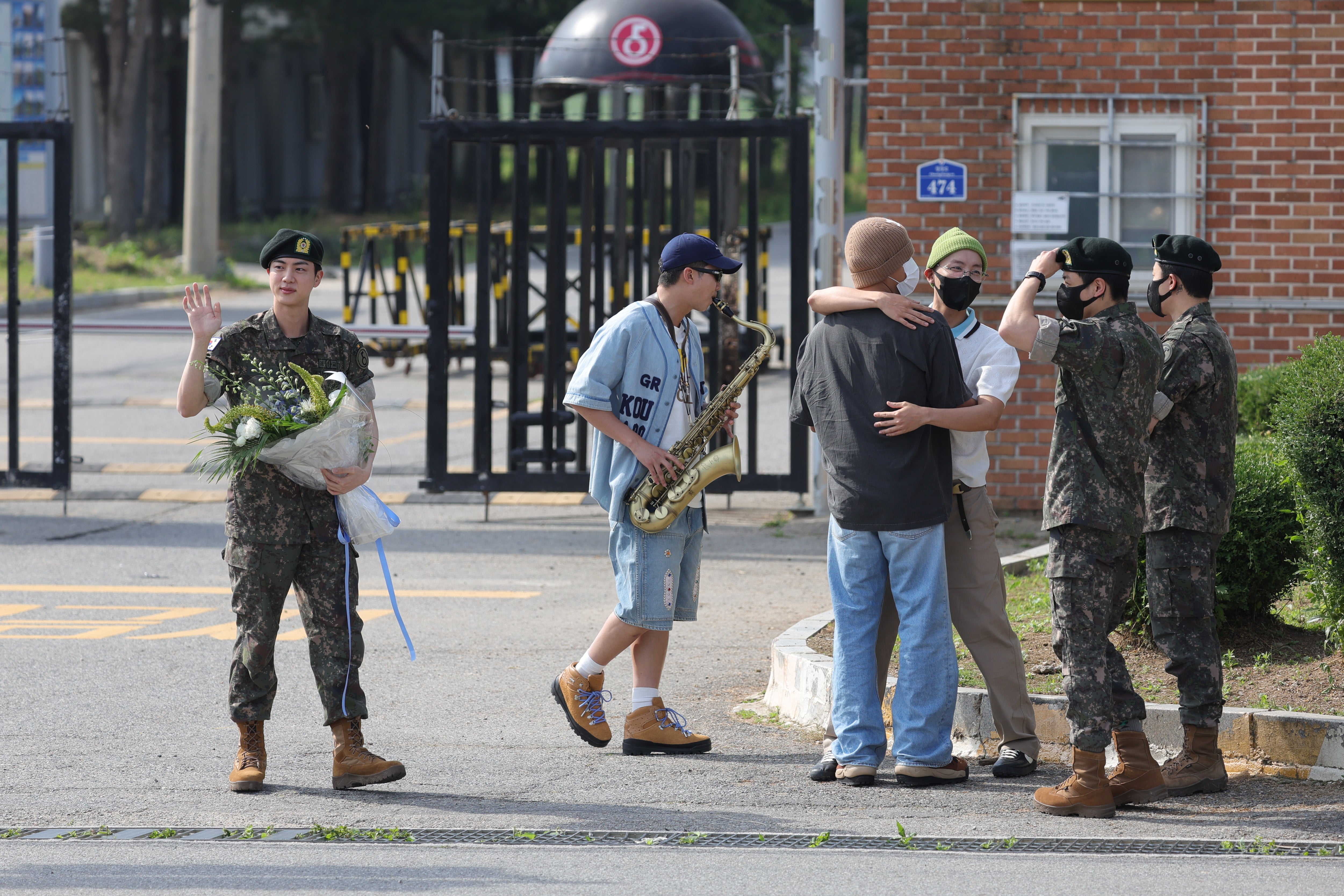 BTS member Jin (L) is welcomed by his bandmates (2-L-R) Jimin, Jungkook, j-hope, V, and RM in front of the main gate of the Army’s 5th Infantry Division after completing his 18 months of mandatory military service in Yeoncheon, South Korea, 12 June 2024