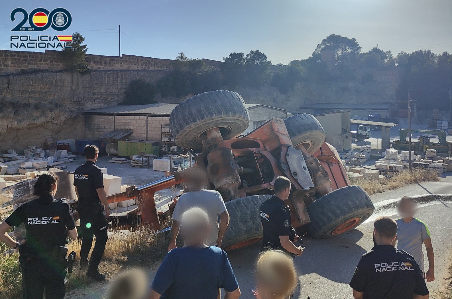 Police investigate the overturned excavator