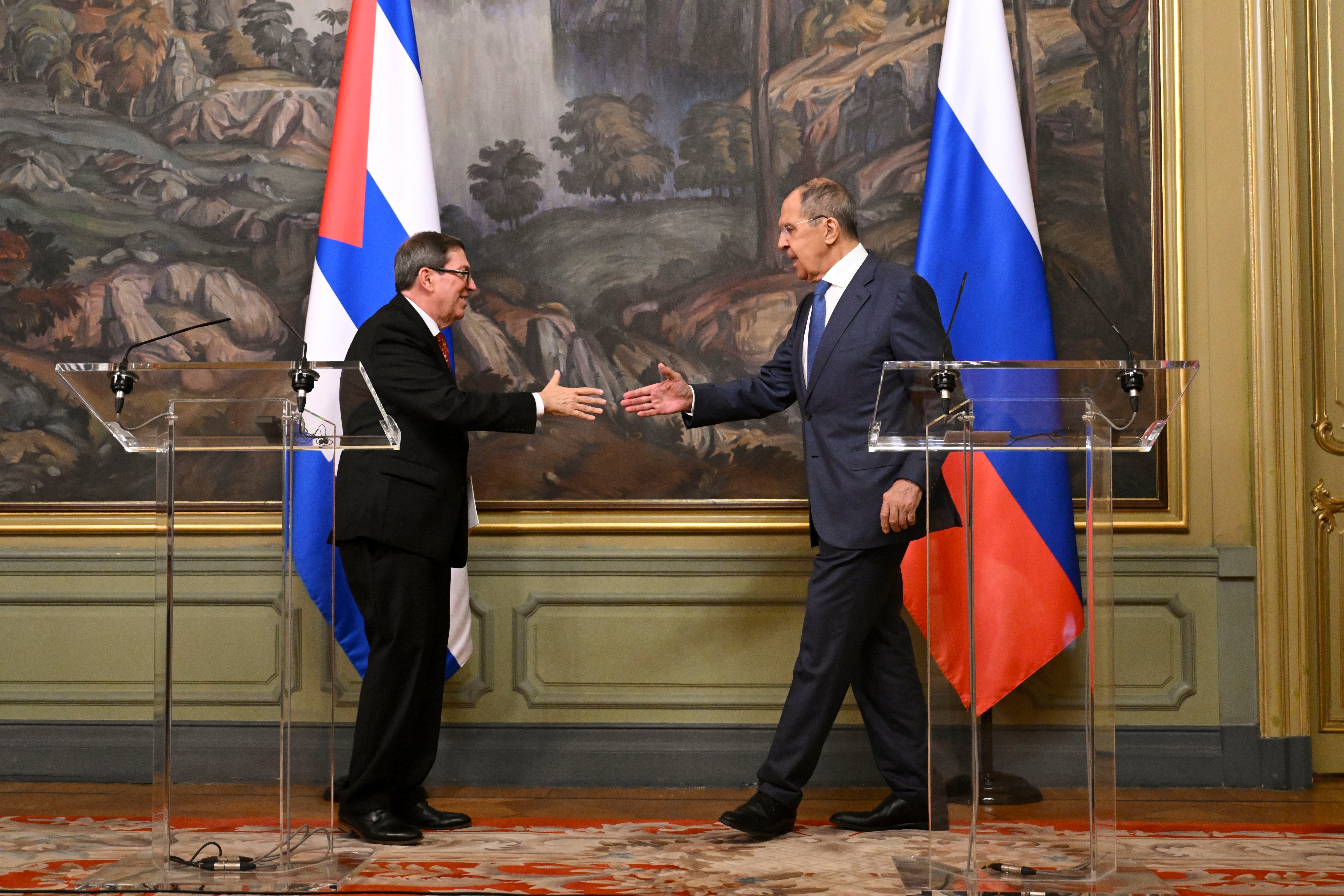 Russian Foreign Minister Sergey Lavrov, right, and his Cuban counterpart Bruno Eduardo Rodríguez Parrilla shake hands