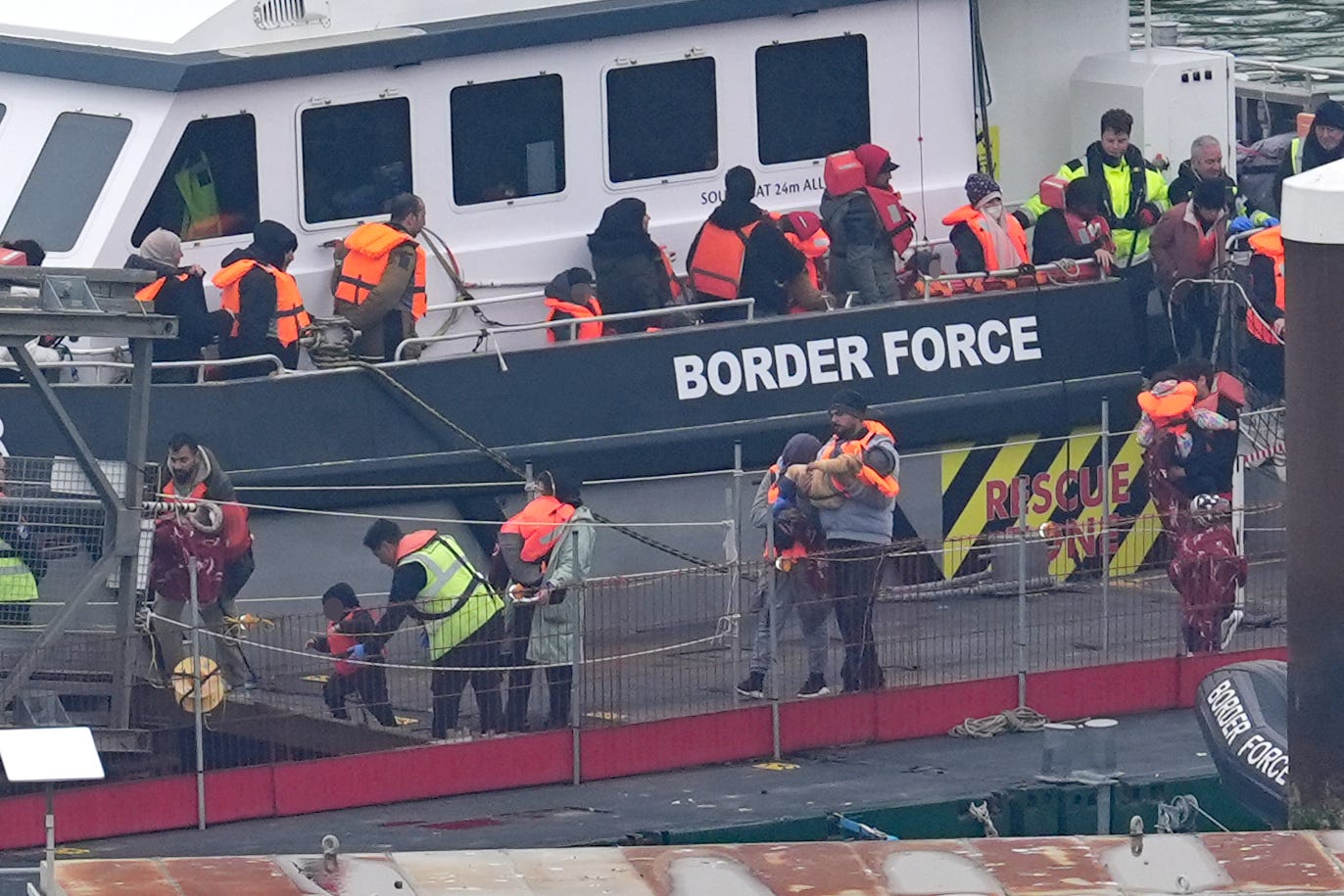 A group of people thought to be migrants, including young children, are brought into Dover from a Border Force vessel (Gareth Fuller/PA)