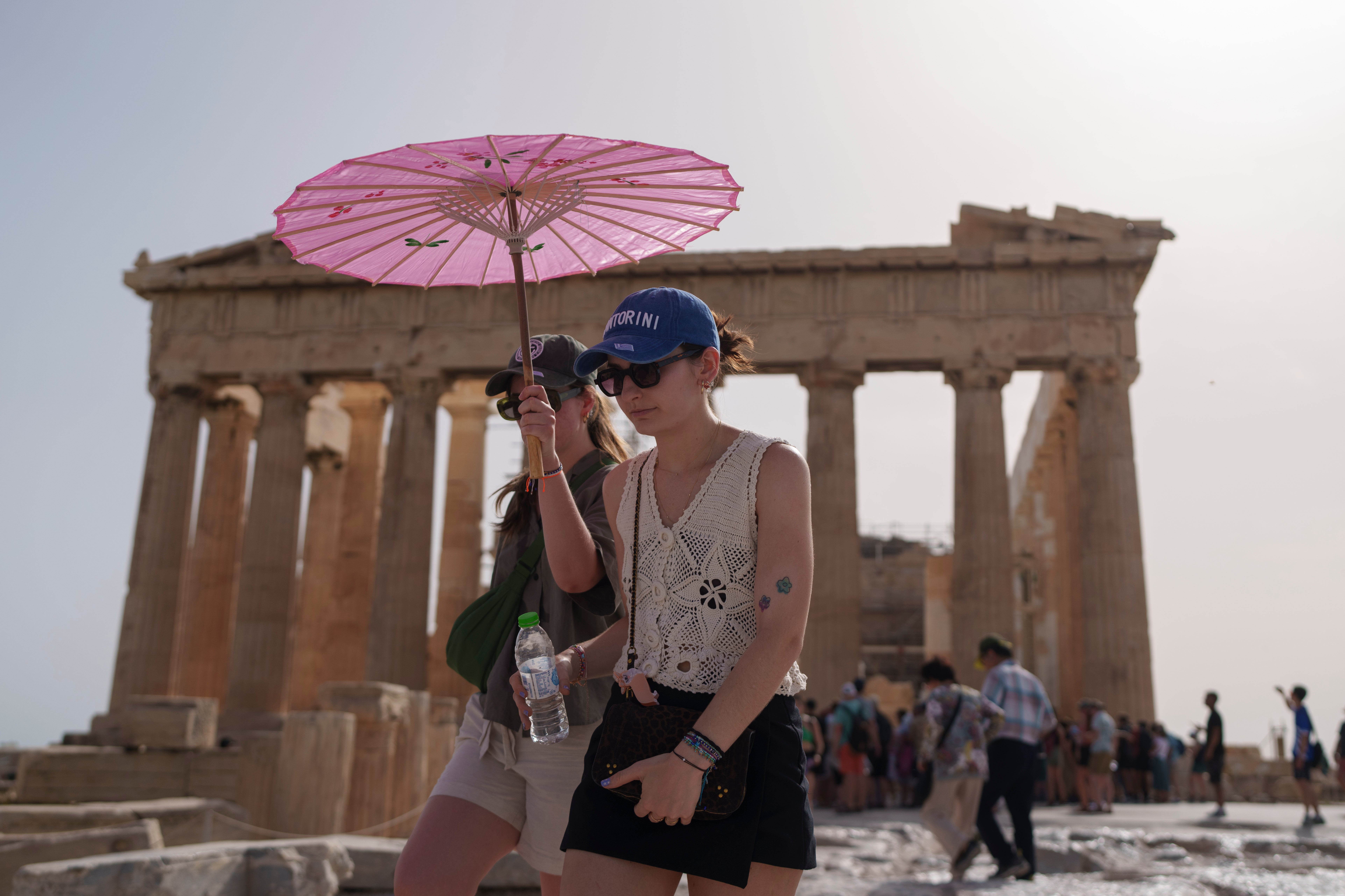 Tourists have been facing the extreme heat as parts of Greece succumb to 104F (40C) conditions