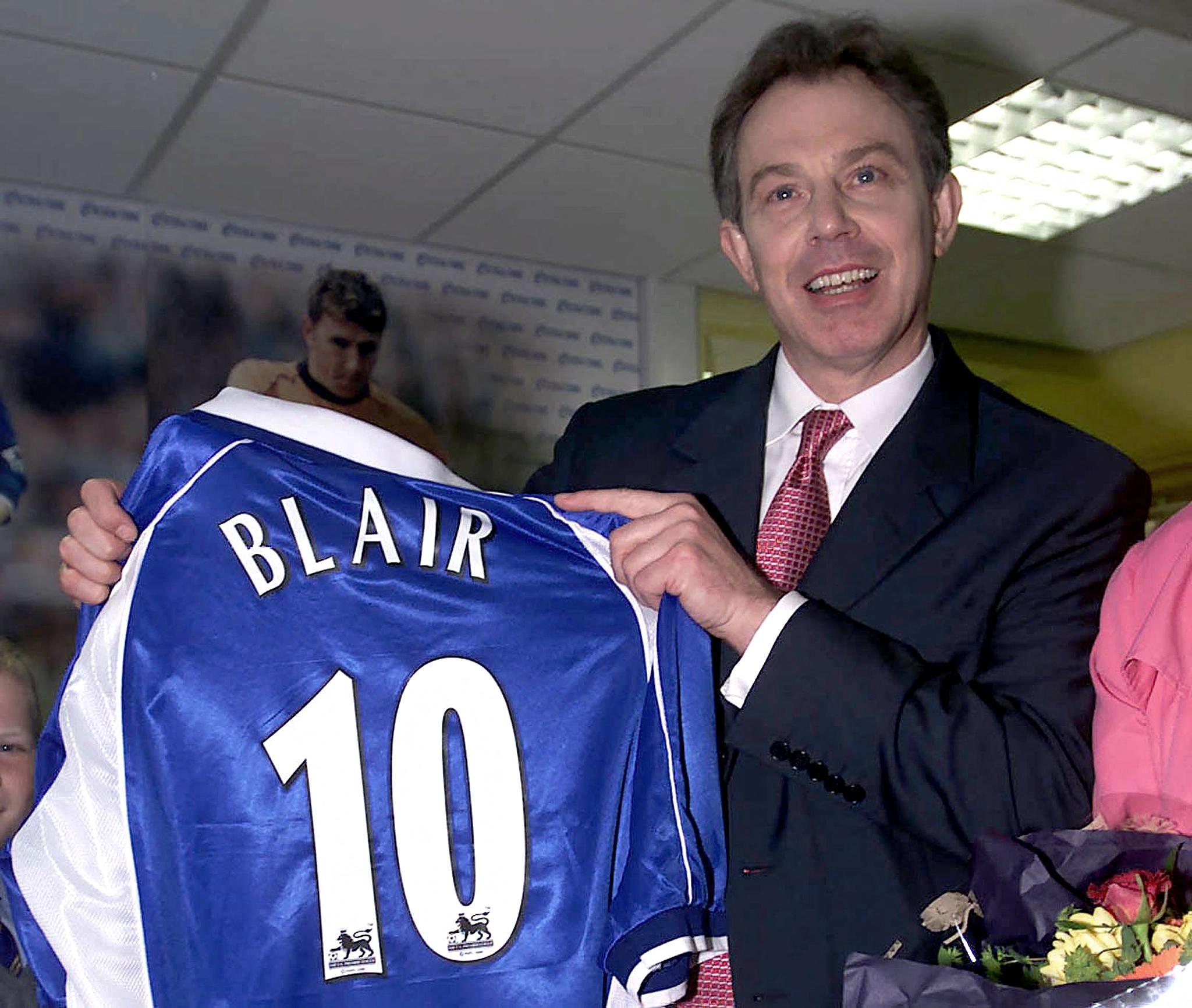 Blair on the ball: the then prime minister holds up a personalised Everton shirt gifted to him during a school visit