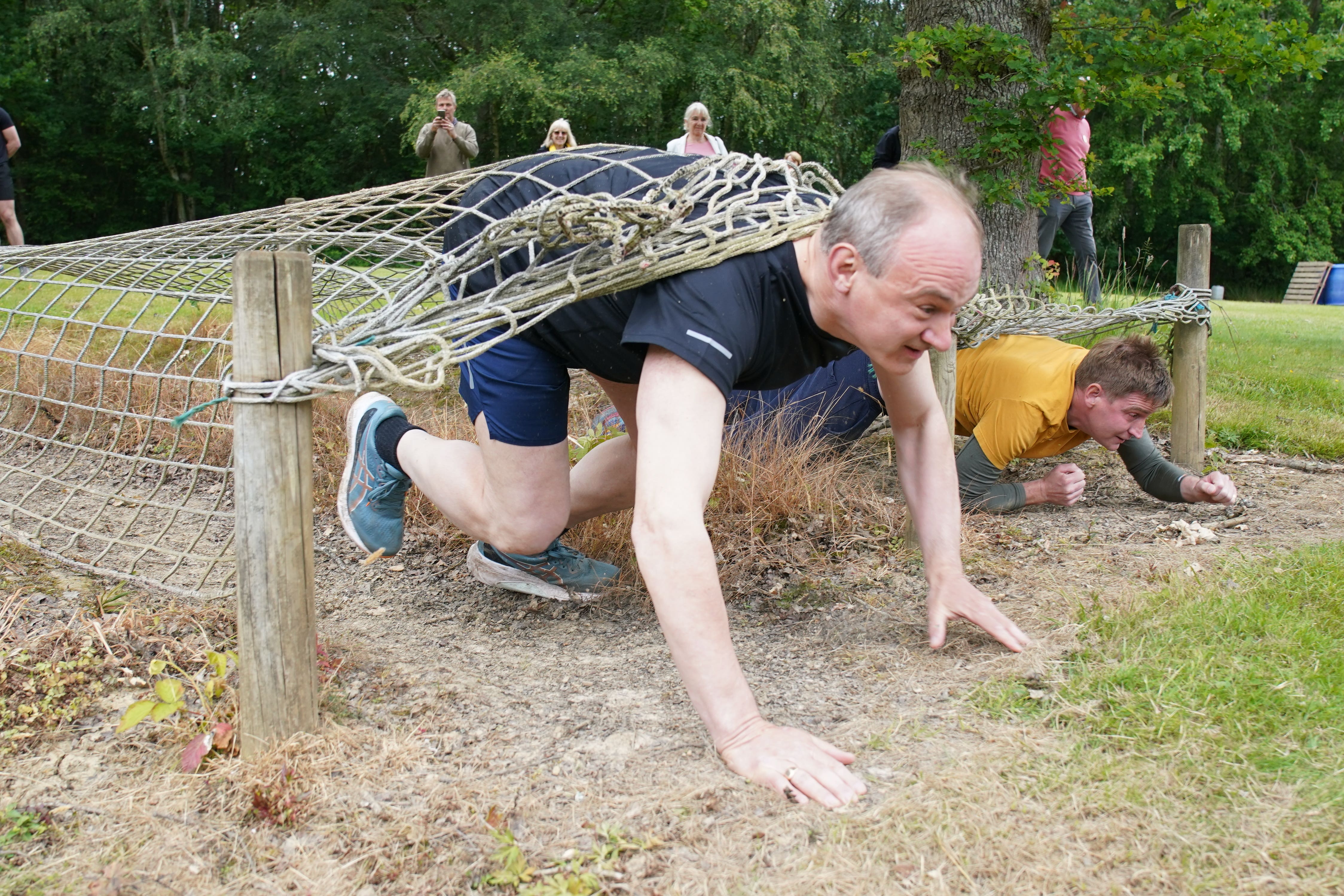 Lib Dem leader Sir Ed Davey on an assault course during a visit to Kent (Gareth Fuller/PA)