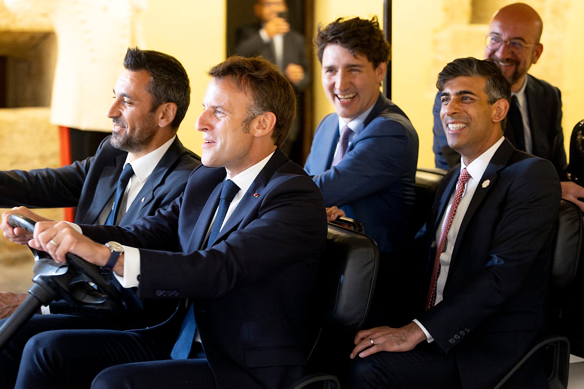 French president Emmanuel Macron driving a golf car with British PM Rishi Sunak, president of the European Council Charles Michel and Canadian PM Justin Trudeau during the G7 summit in Italy