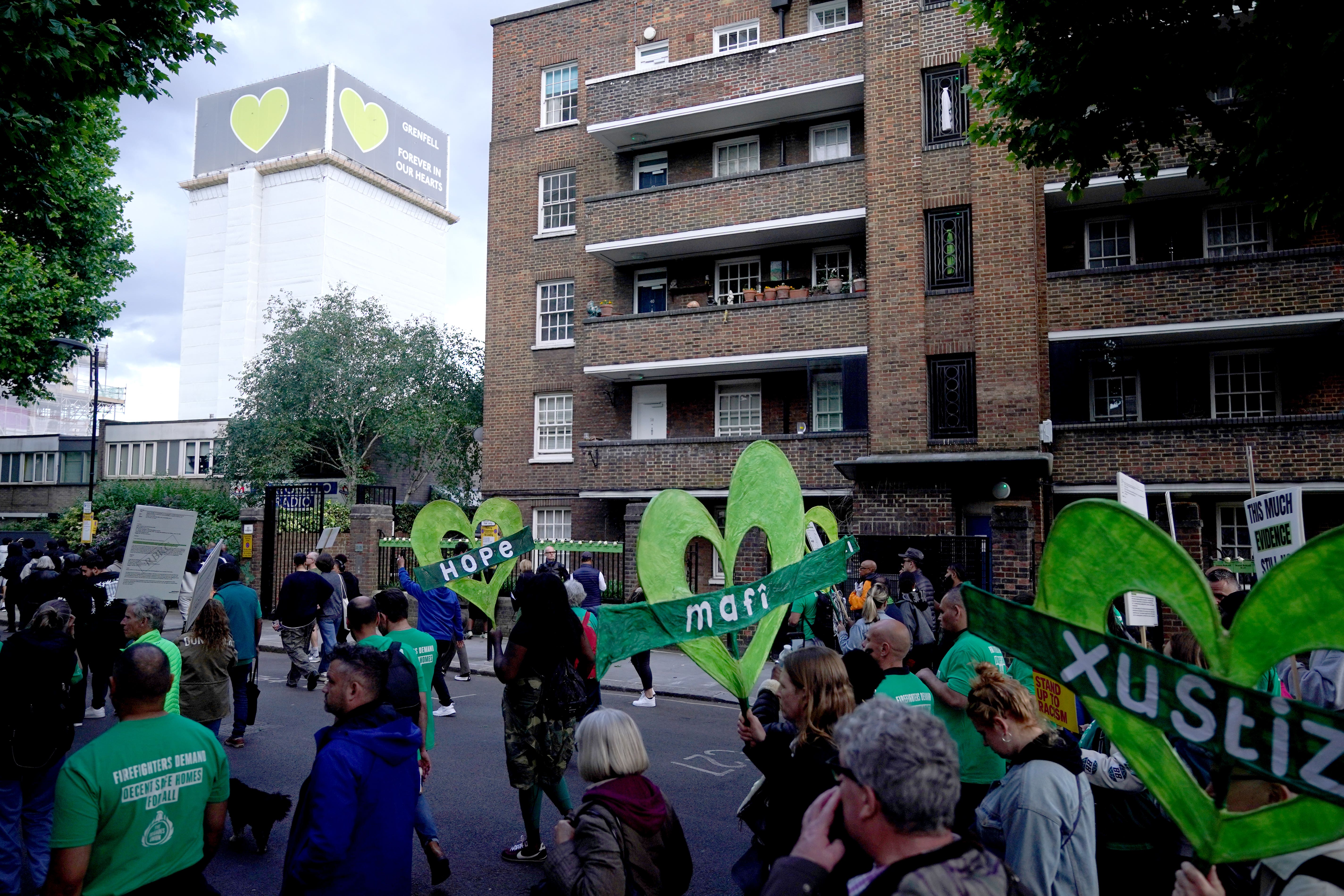 People take part in a silent walk near Grenfell Tower in London (Yui Mok/PA)